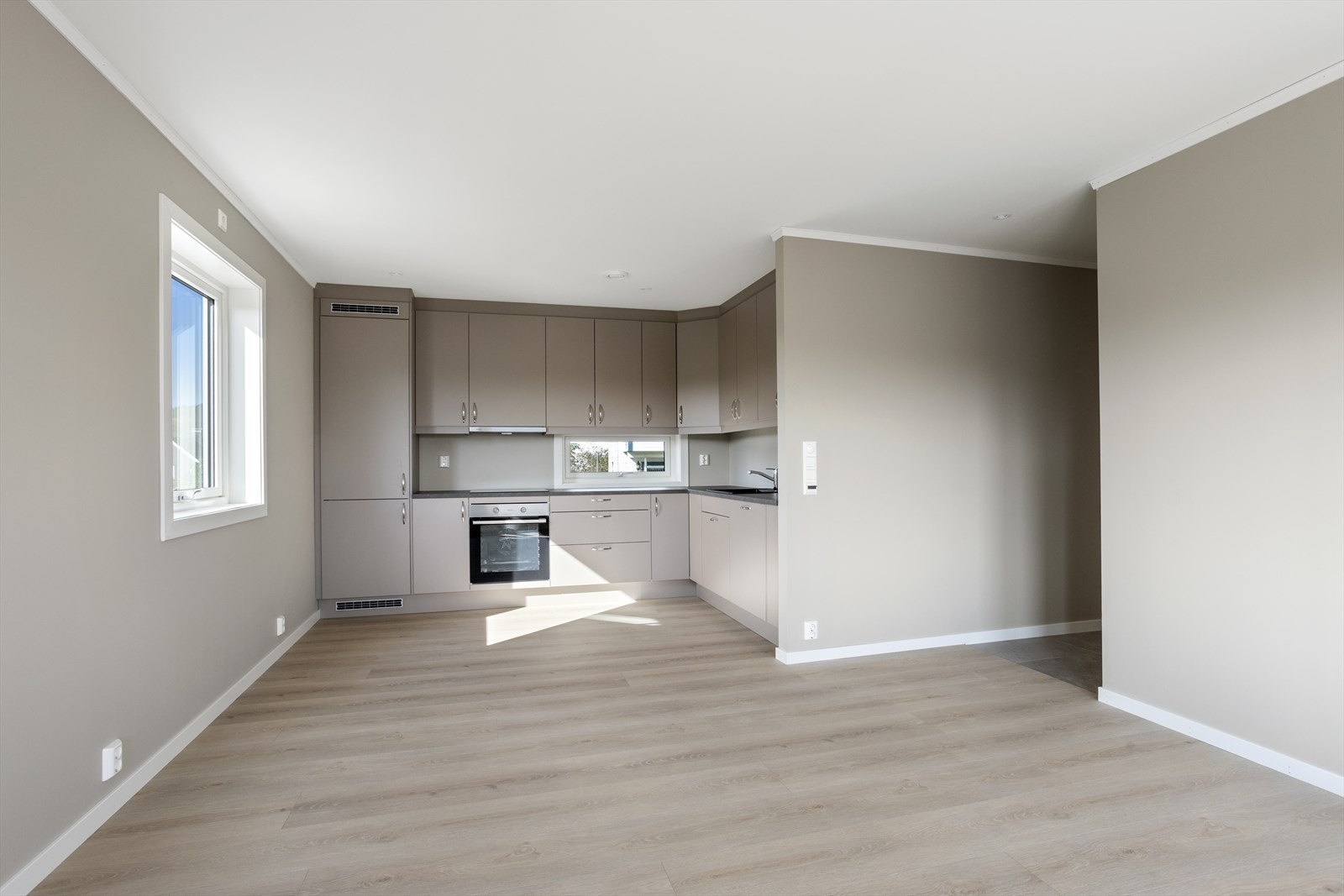 Leiligheten ligger fint til i byggets første etasje og inneholder entré, baderom, bod/vaskerom, stue/kjøkken i åpen løsning og to soverom. (Bilde av naboleilighet med speilvendt planløsning) Galleribilde