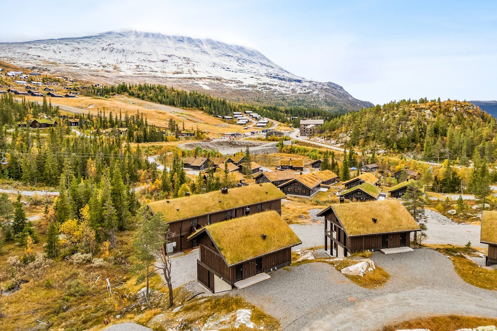 Hytta er oppført i 2023 med torvtak og grov stående panel Galleribilde