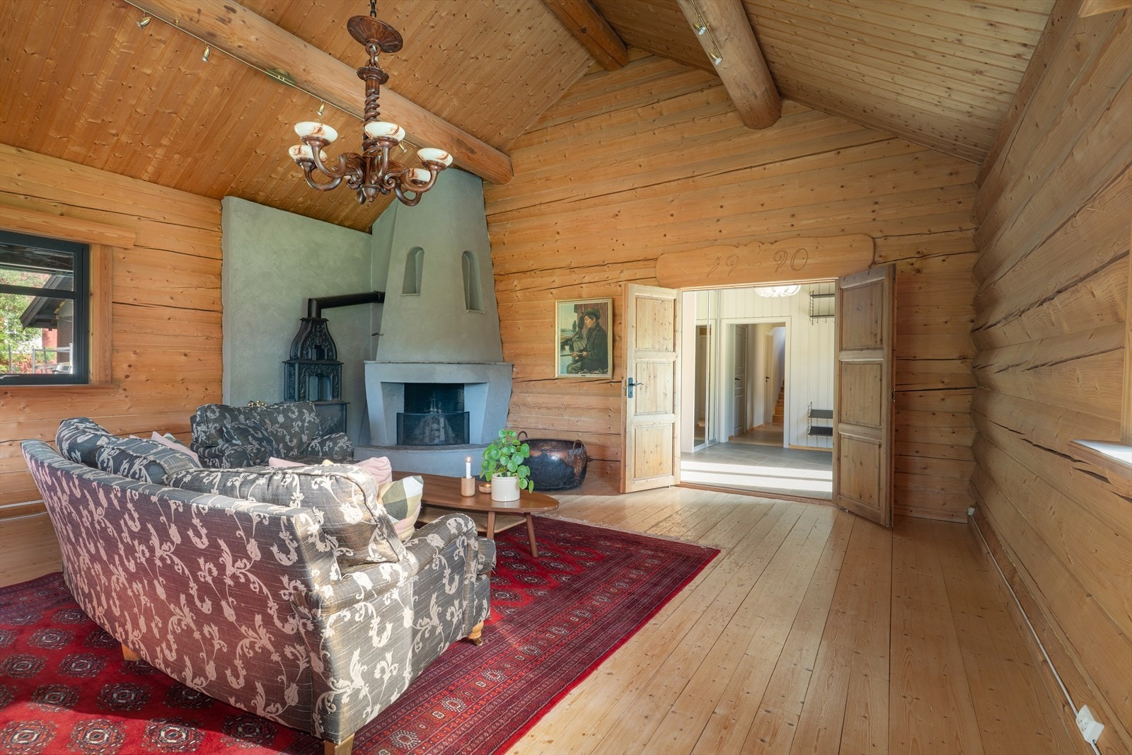 Stua med lafta vegger og vakre detaljer gir rommet et lunt og levende uttrykk med et varmt preg. Galleribilde