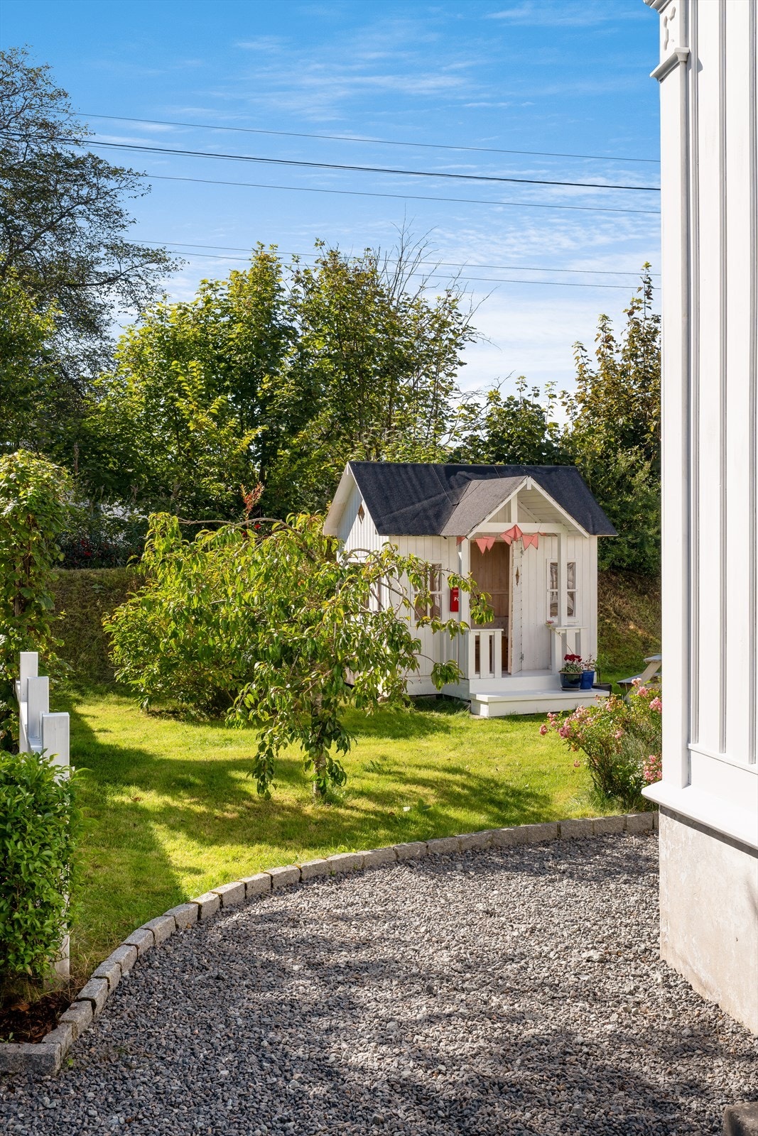 Eiendommen er parkemessig opparbeidet med plen, belegningstein, beplantning, bedd, terrasse og gruset gangsti Galleribilde