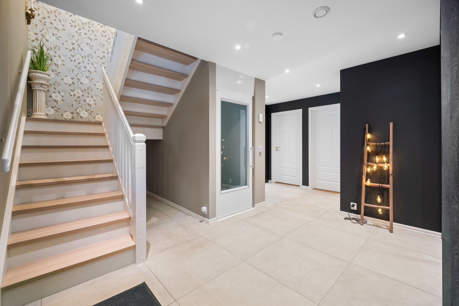 Boligen har ekstra luksus med heis mellom etasjene. Trapperommet har romantisk blomstertapet og takpunkt til lysekrone. Galleribilde