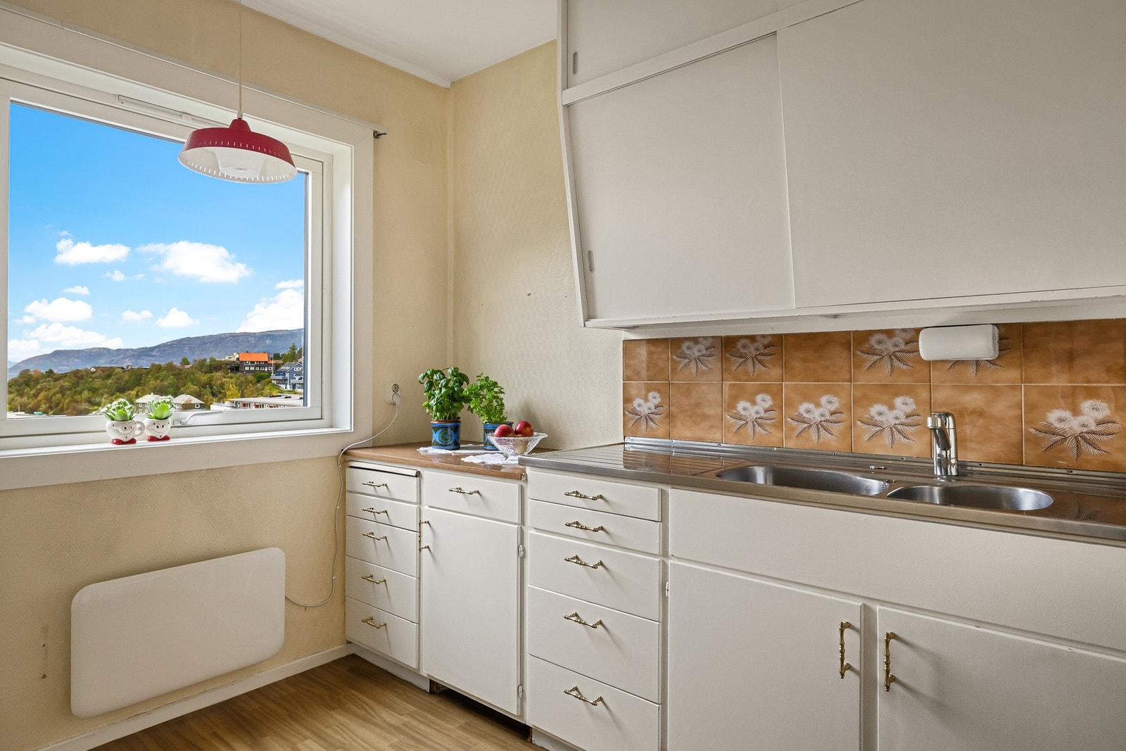 Eldre kjøkkeninnredning med slette fronter og laminat benkeplate Galleribilde