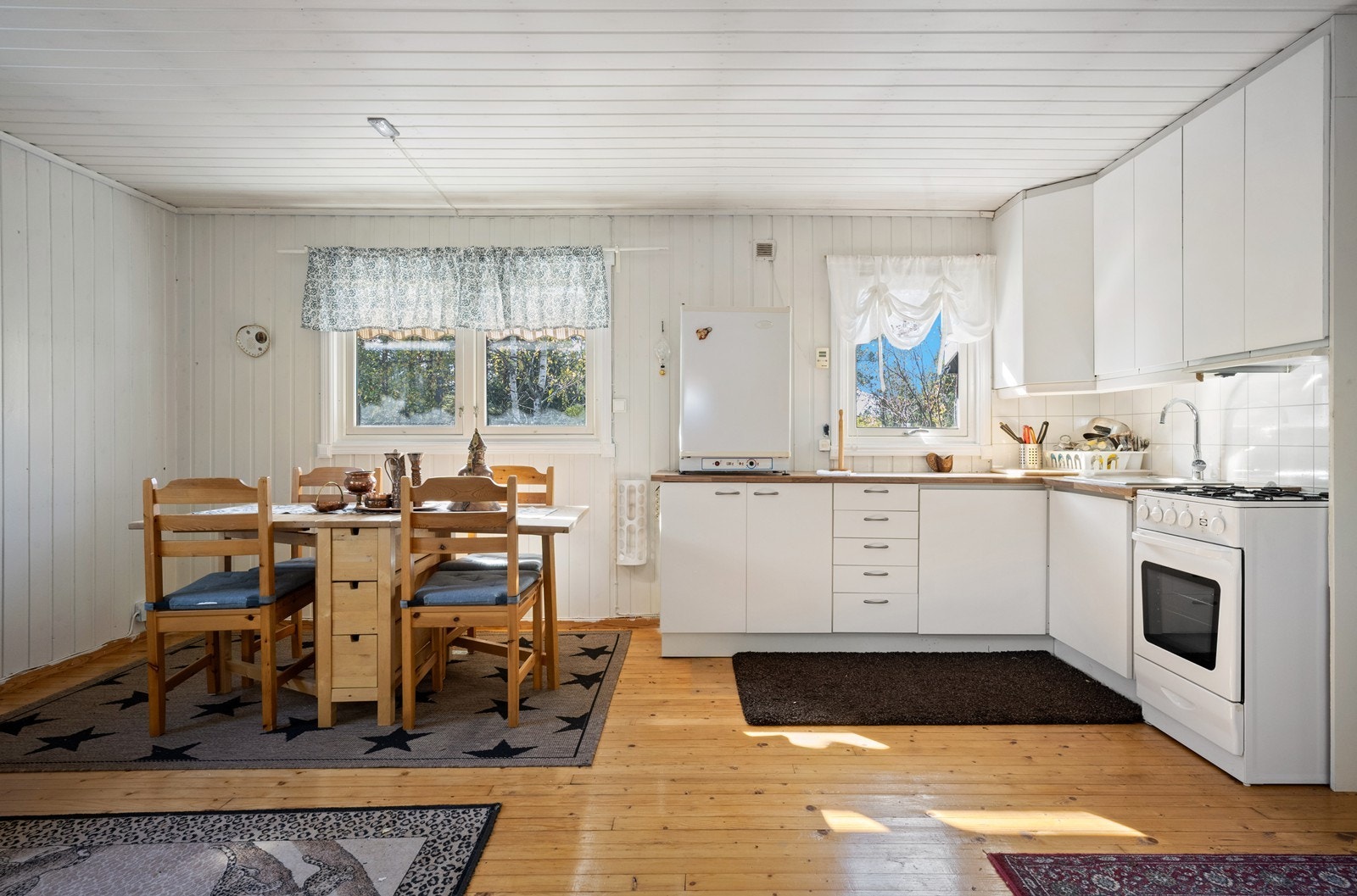 Kjøkkeninnredning fra nyere dato. Kjøkkenet har slette fronter og laminat benkeplate. Frittstående gasskomfyr og gasskjøleskap. Galleribilde