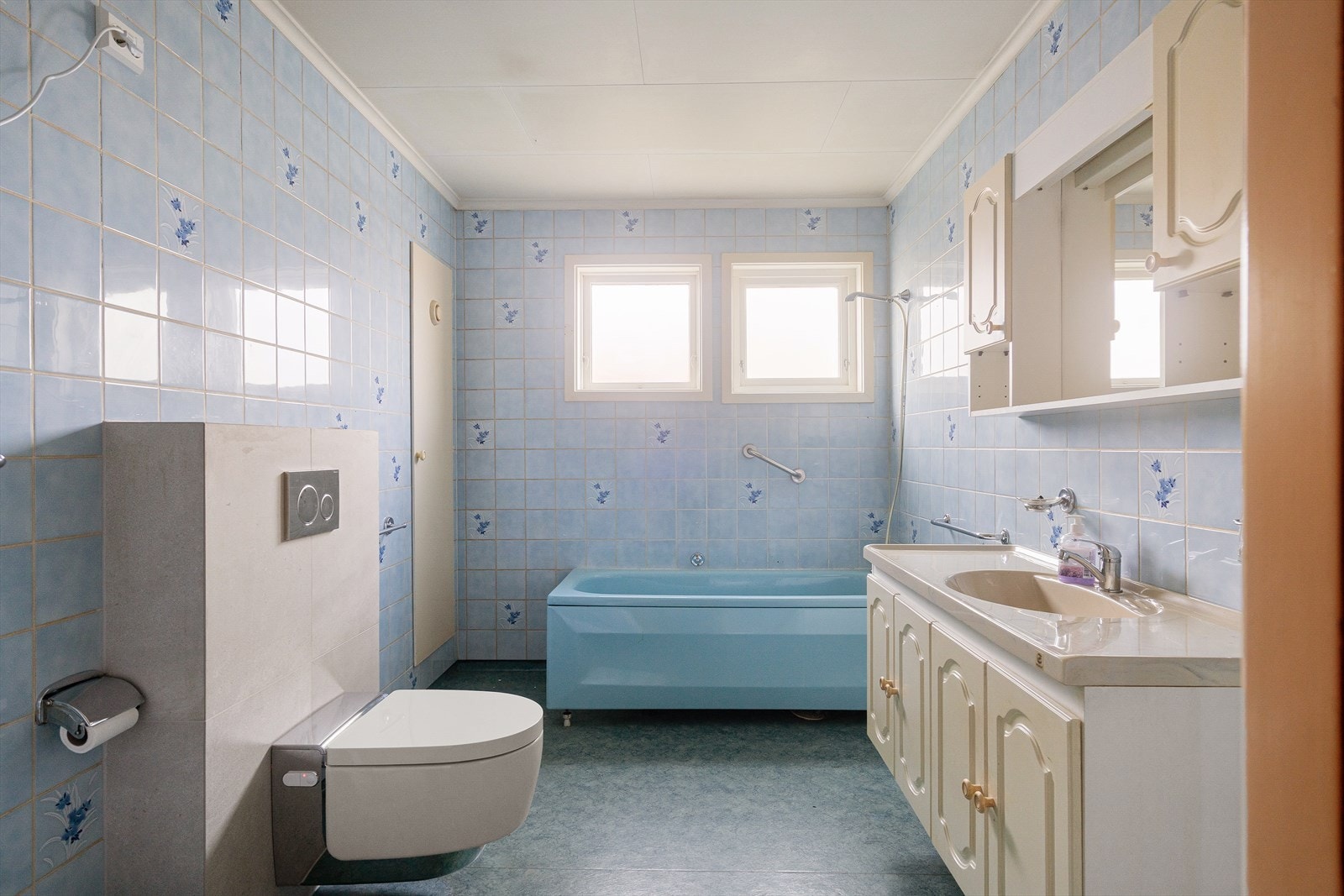 Flislagt bad med vegghengt toalett og praktisk oppbevaring gir en funksjonell hverdag. Galleribilde