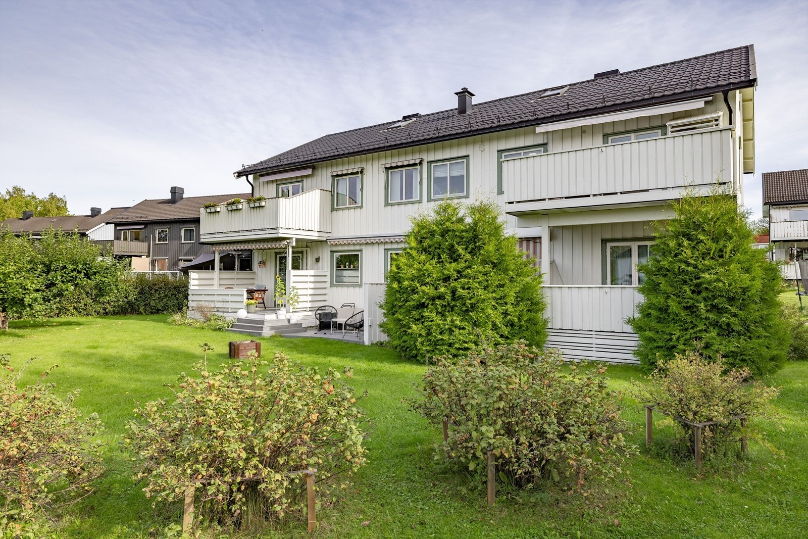 Fellestomten er pent opparbeidet med plen, trær og diverse bærbusker. Galleribilde