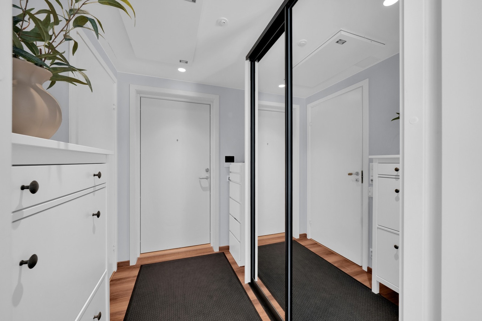 Lys og stilren entré med stor skyvedørsgarderobe Galleribilde