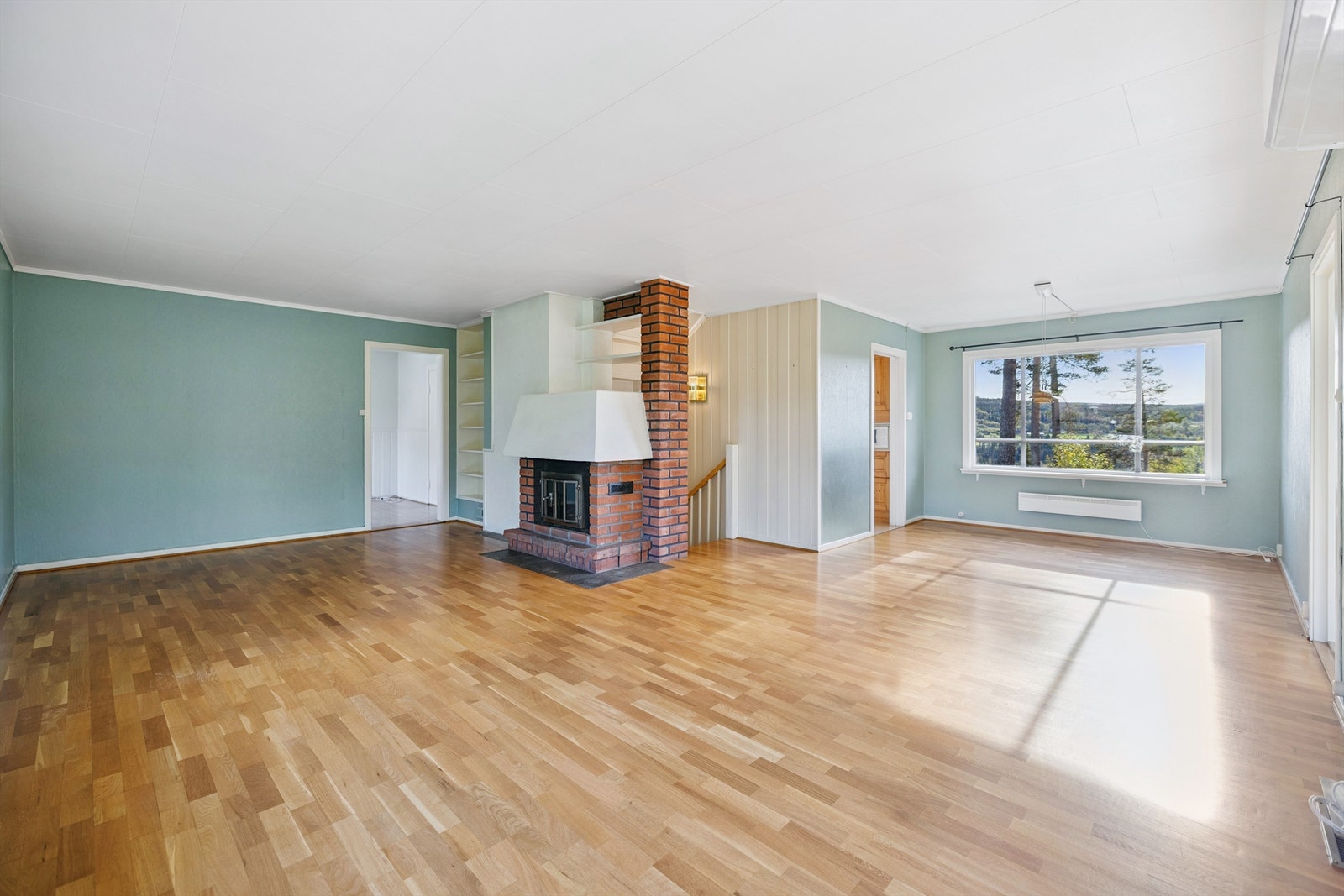 Stuen er et romslig samlingspunkt med en teglsteinsforblendet peis med innsats. Galleribilde