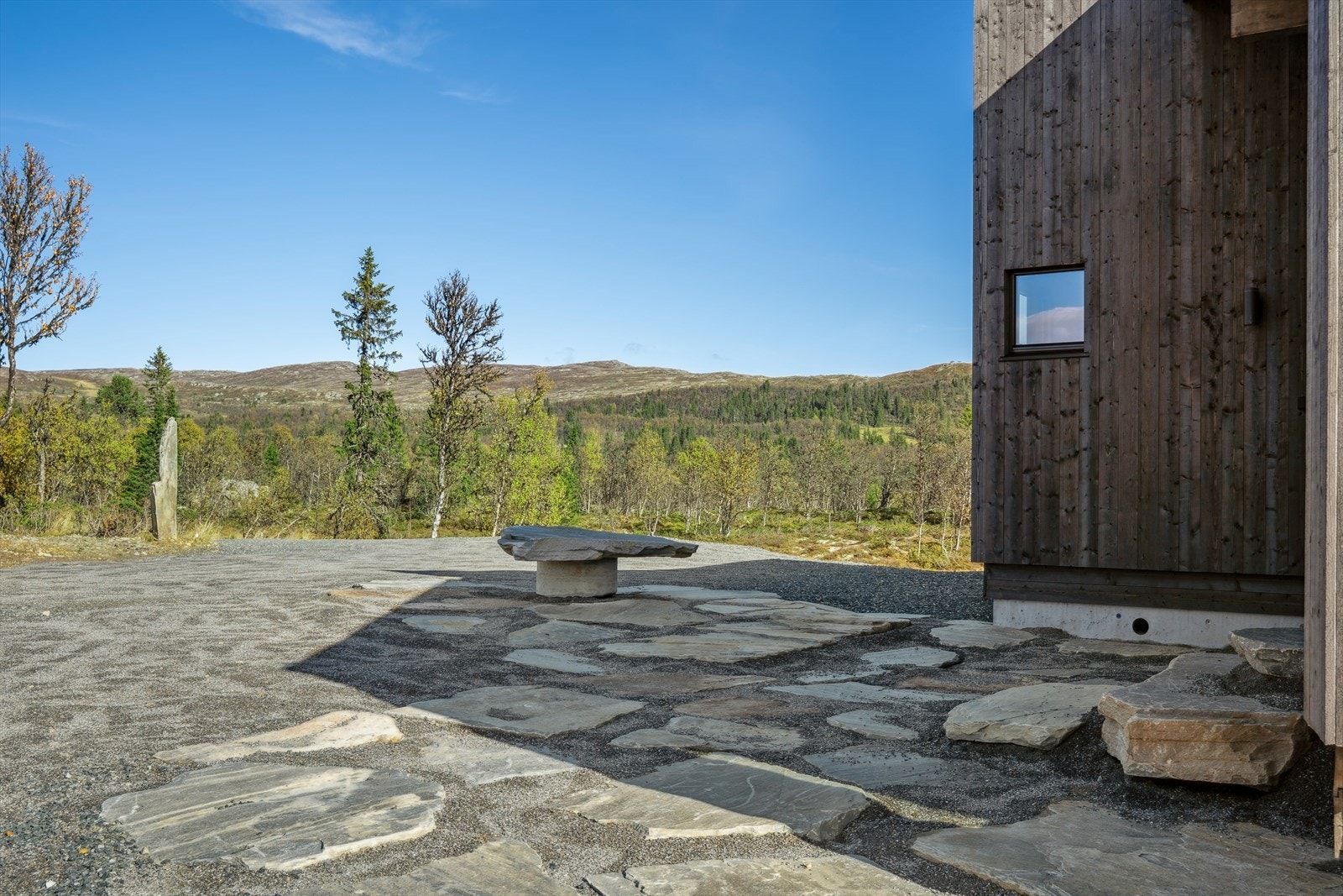 Det er opparbeidet flatt terreng rundt hytta. Galleribilde