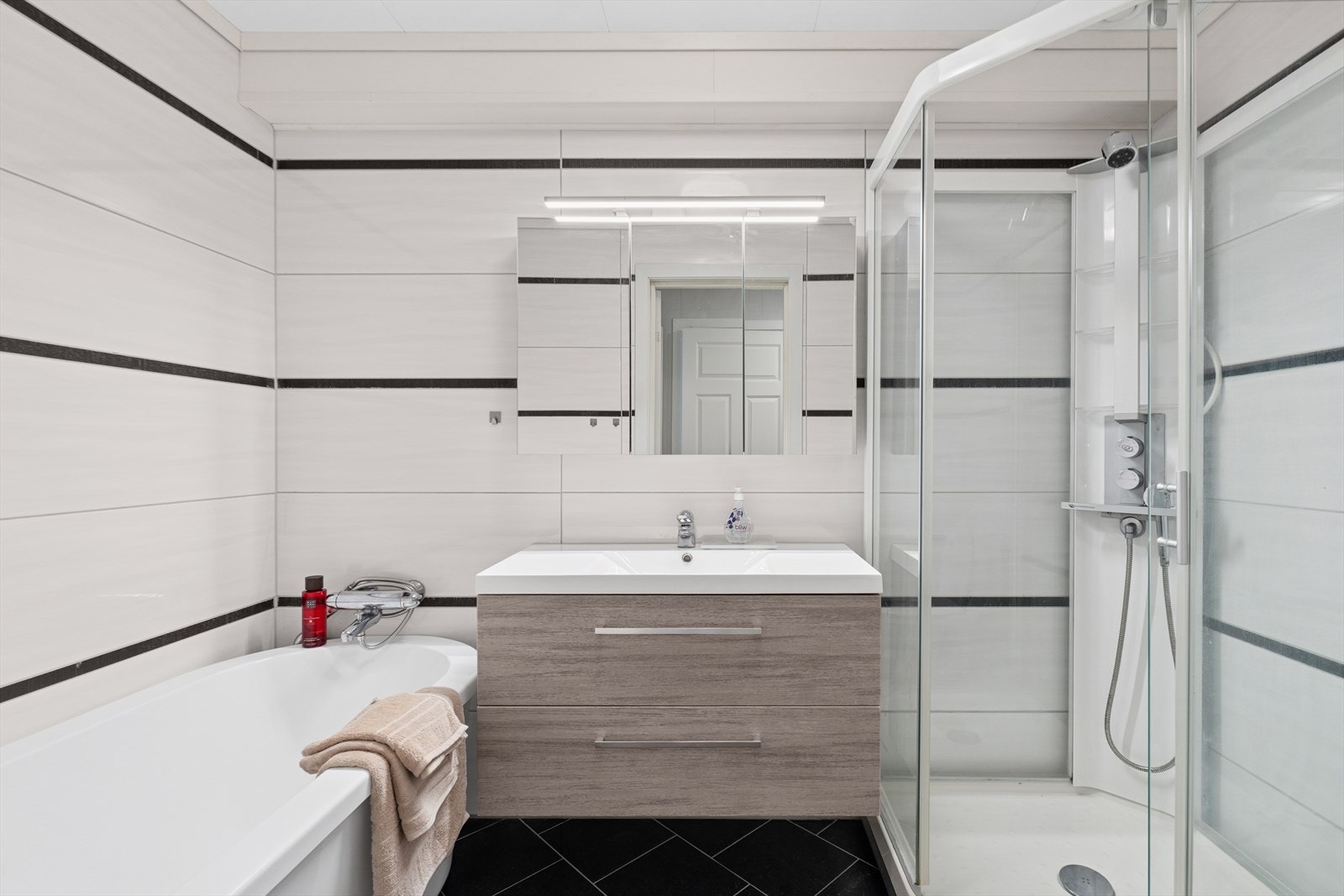 Pent helfliset bad fra byggeår. Rommet er innredet med servantskap, wc, badekar og dusjkabinett. Mekanisk ventilert. Et godt sted å starte dagen! Galleribilde