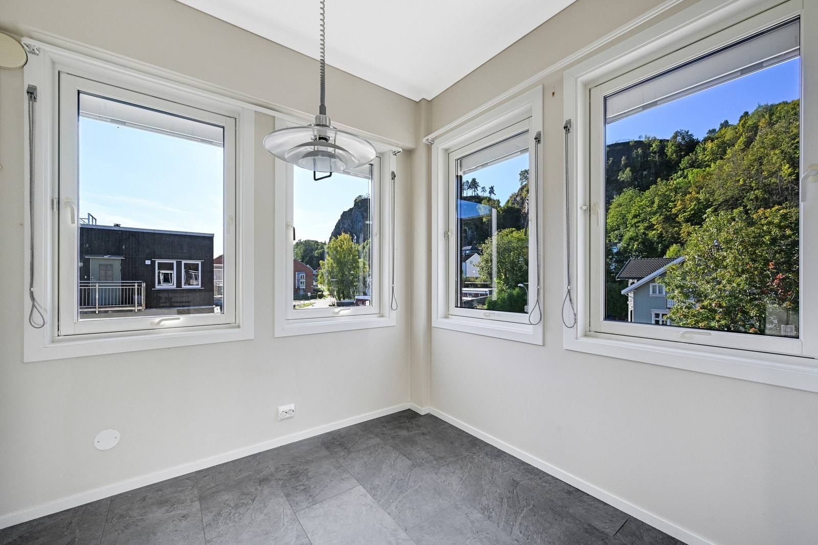 Kjøkkenet kan by på med fire store vinduer som gir mye naturlig lys og utsikt til nabolaget og oppover fjellet. Galleribilde