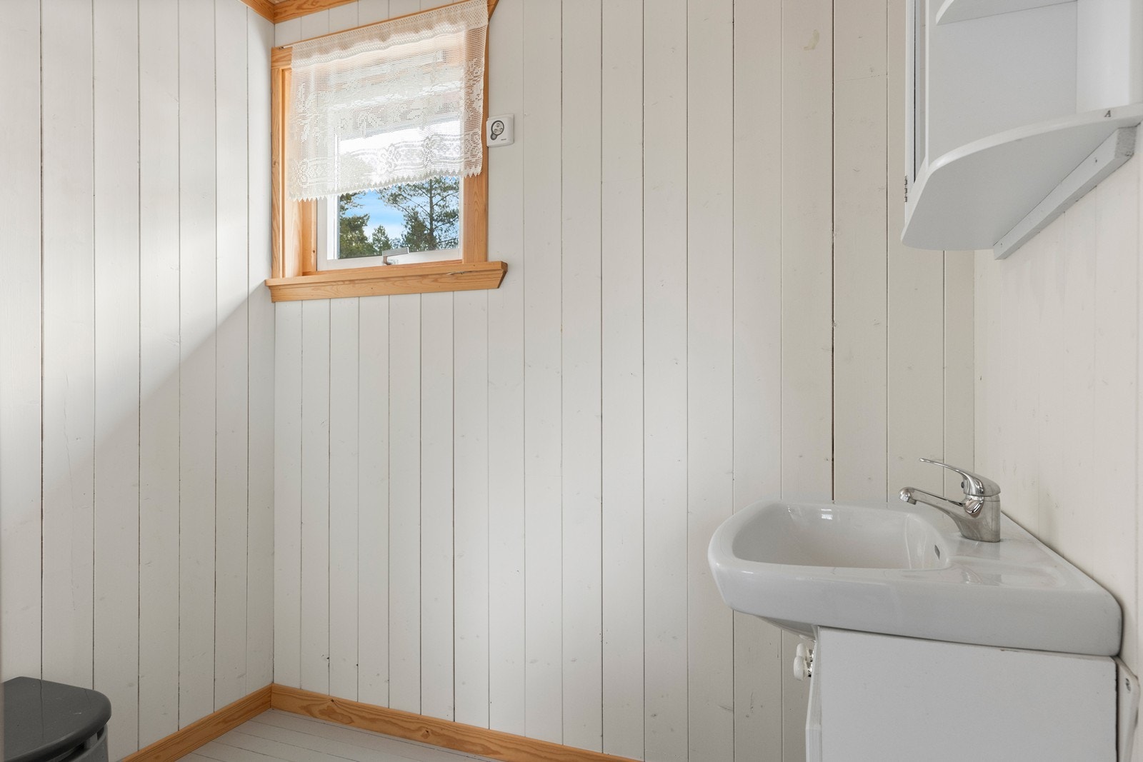 Enkelt rom med vask utstyr i servant med over- og under skap. Galleribilde