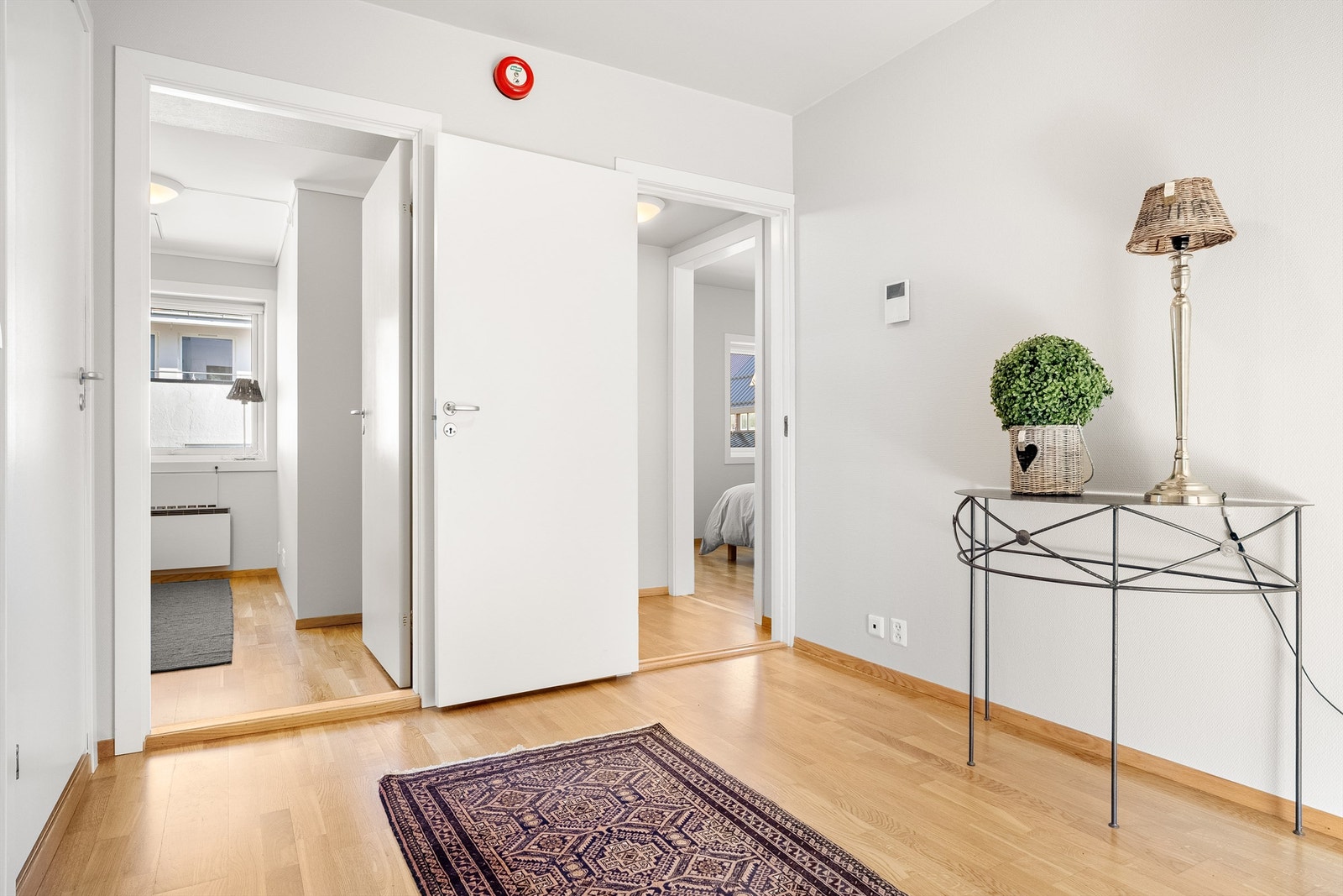 Fra entrèen er det dør inn til venstre til bad/vaskerom og videre inn til de to soverommene. I entrèen er det montert porttelefon med kamera. Galleribilde