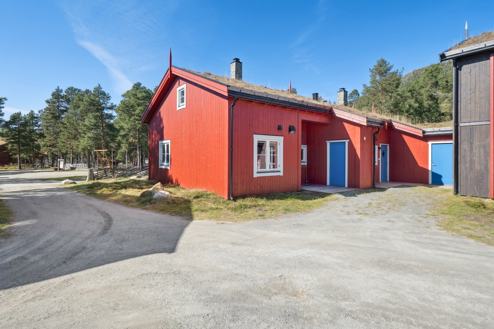 Flatt parti rundt leiligheten med opparbeidet med plen og innhegnet med skigard. Galleribilde