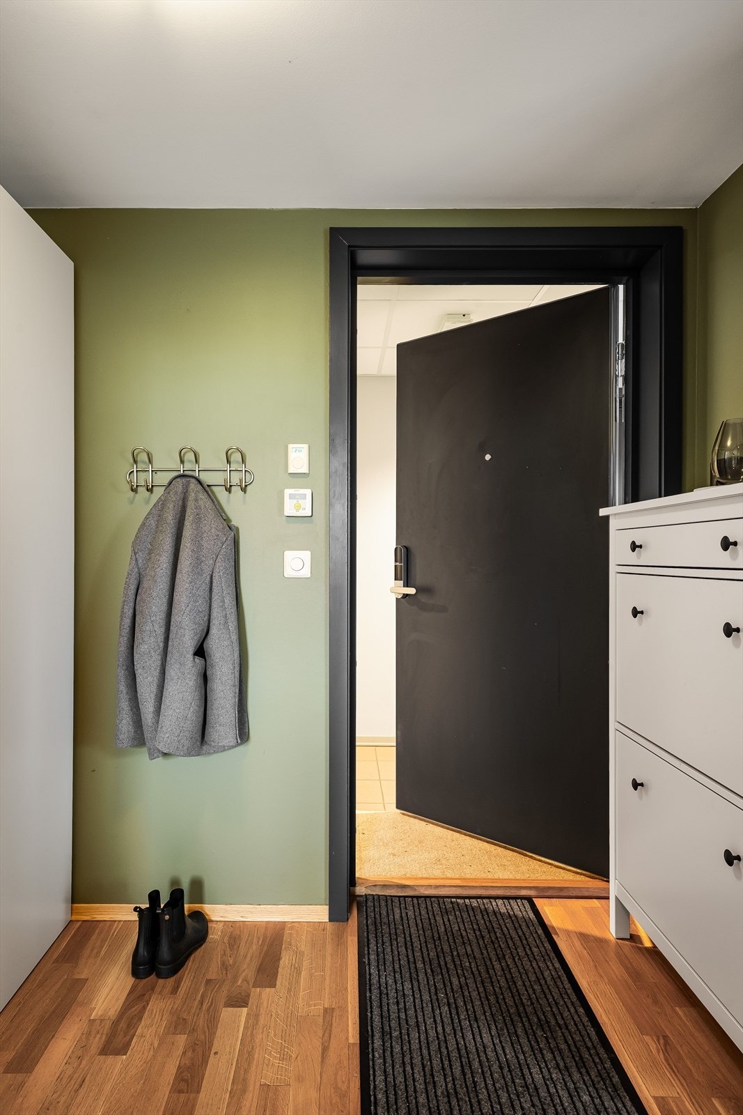 Du ønskes velkommen inn i en varm og innbydende entre. Det ble i 2025 montert kodelås på ytterdøren inn til leiligheten. Galleribilde