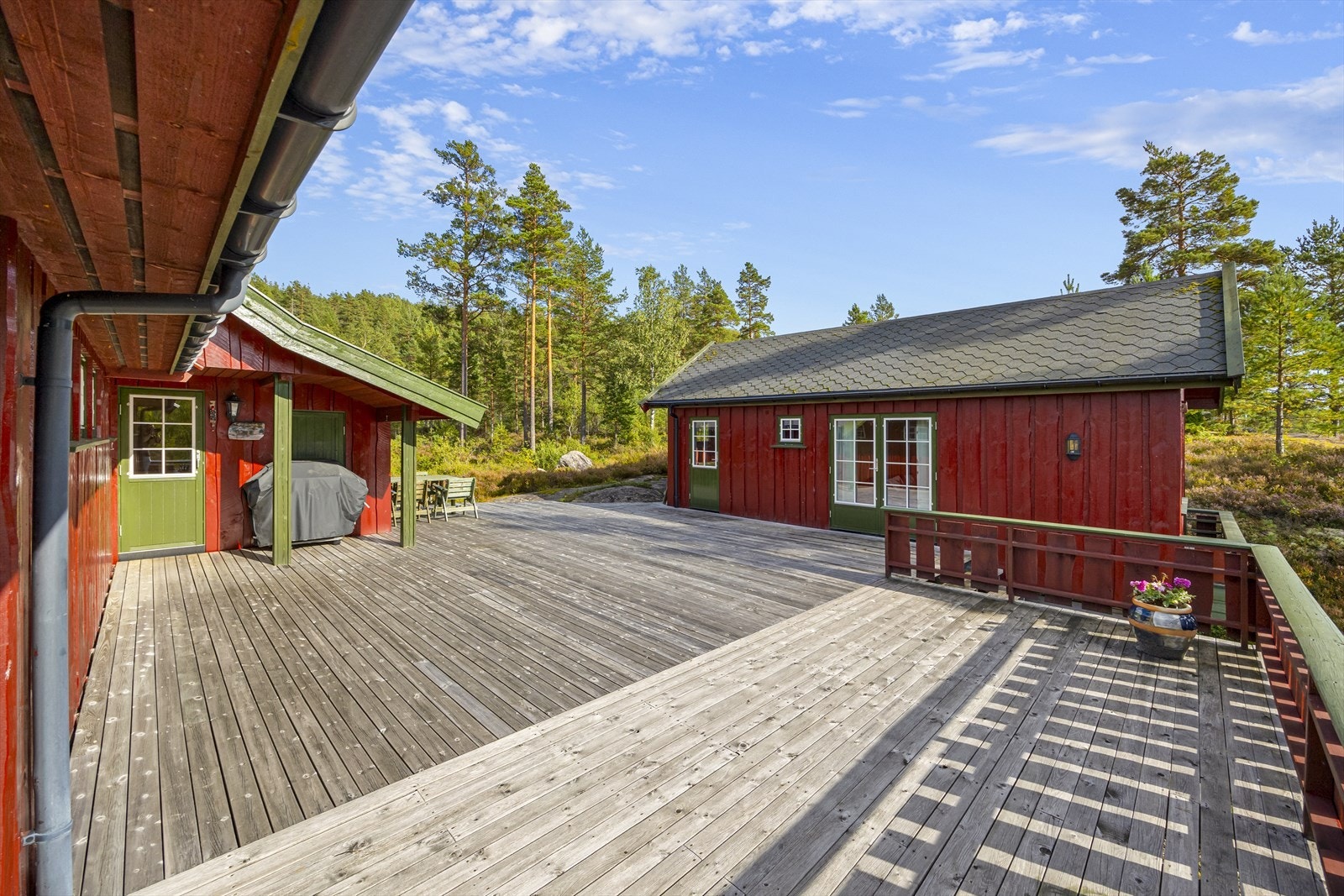 Stor, solrik terrasse med flere soner for sittegrupper og utendørs hygge. Perfekt for lange sommerdager med familie og venner. Fantastisk utsikt mot vann og skogkledde åser. Galleribilde