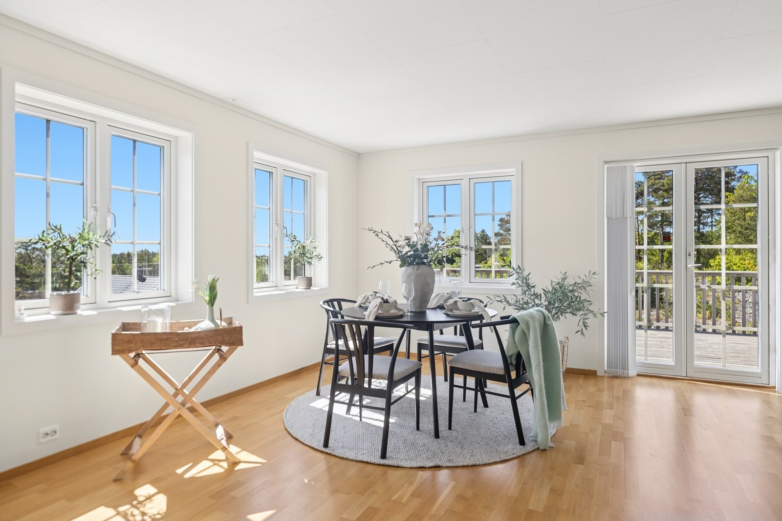 Spisestuen sett fra en annen vinkel, med direkte tilgang til solrik terrasse. Lysinnslipp fra tre himmelretninger gir et lyst og åpent uttrykk..jpg Galleribilde