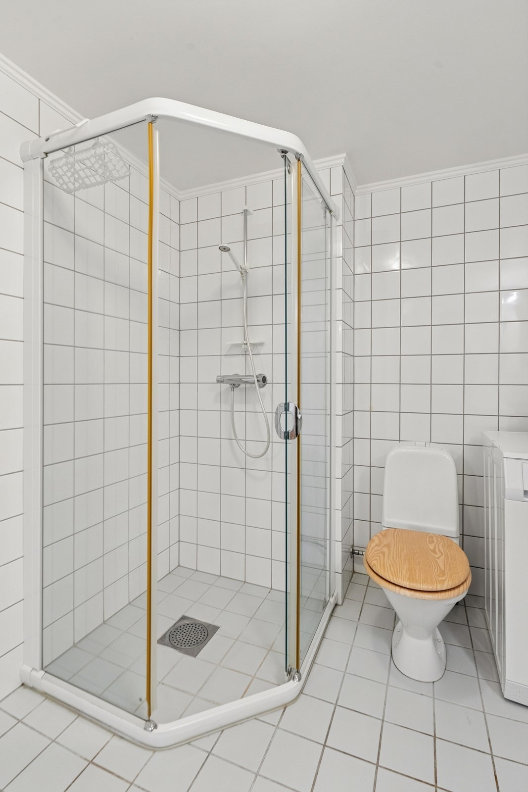 Rommet er utstyrt med servantinnredning, dusjhjørne med glassvegger og toalett. Galleribilde