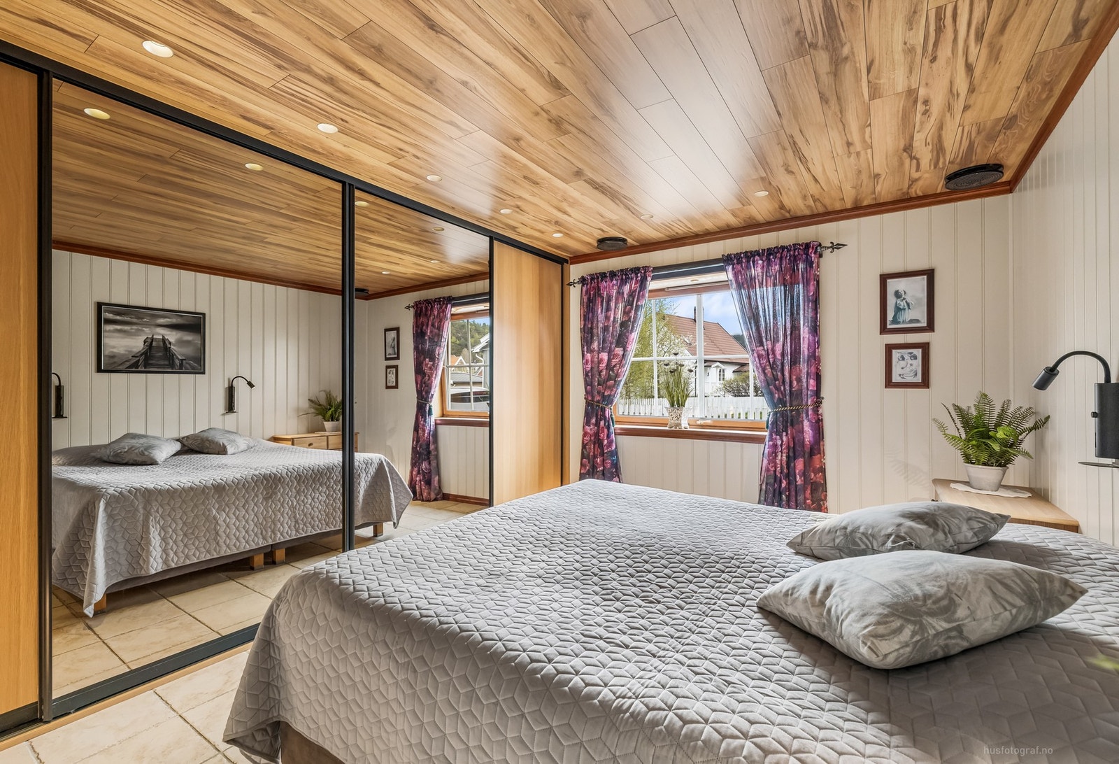 ovedsoverommet har flislagt gulv, panelerte vegger og himling med laminat og downlights Galleribilde