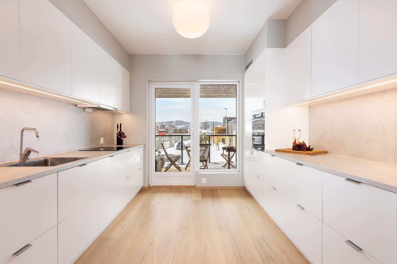 Benkeplatene er videreført opp under overskapene og gir et fint helhetsinntrykk. I skap over stekeovn er det stikkontakt og plass til mikrobølgeovn. Galleribilde