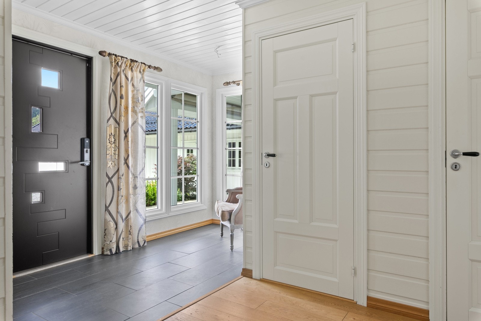 Entre er flislagt, lys og lutfig Galleribilde