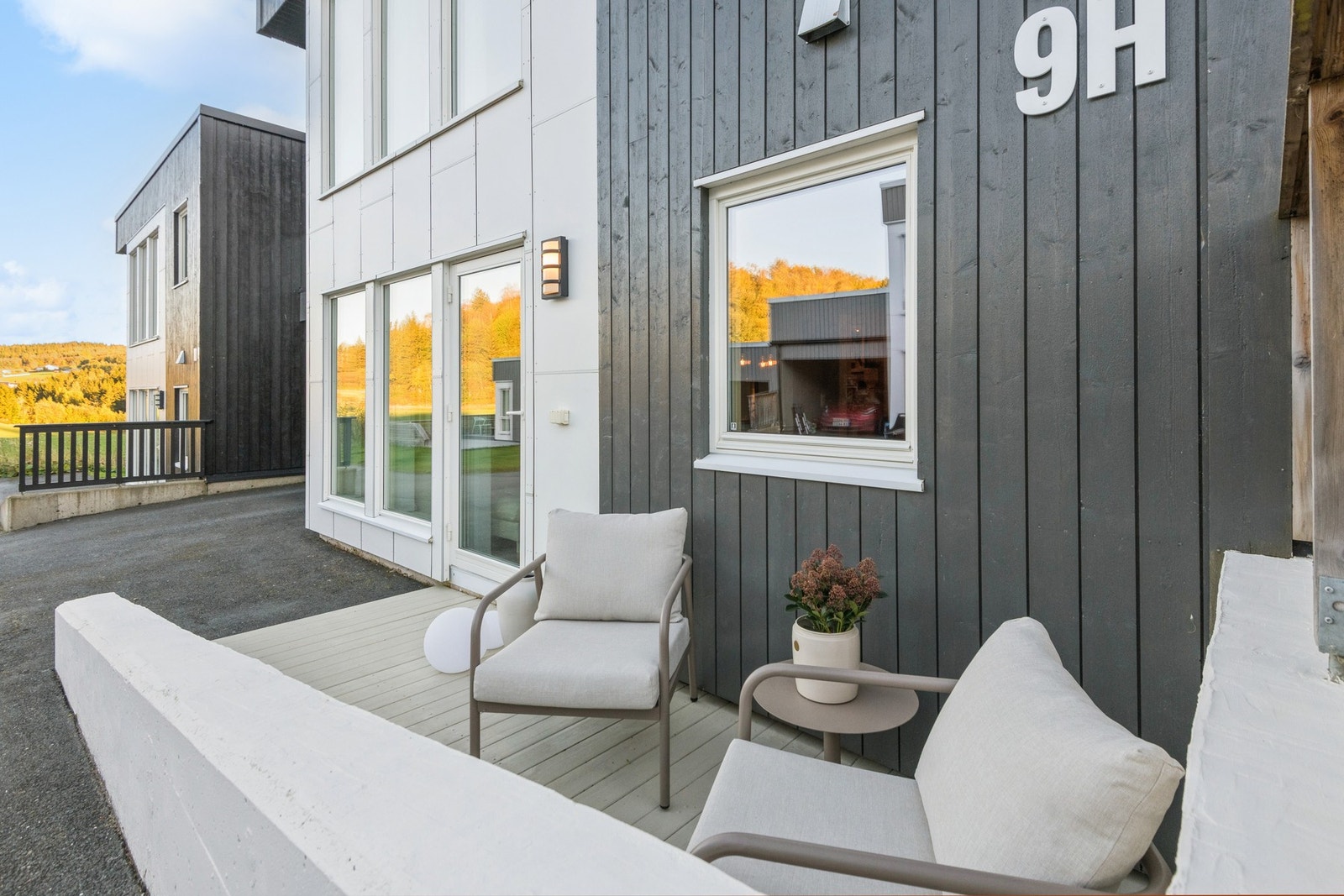 Ved inngangspartiet har man e hyggelig sitteplass, asfaltert gårdsplass og carport. Galleribilde