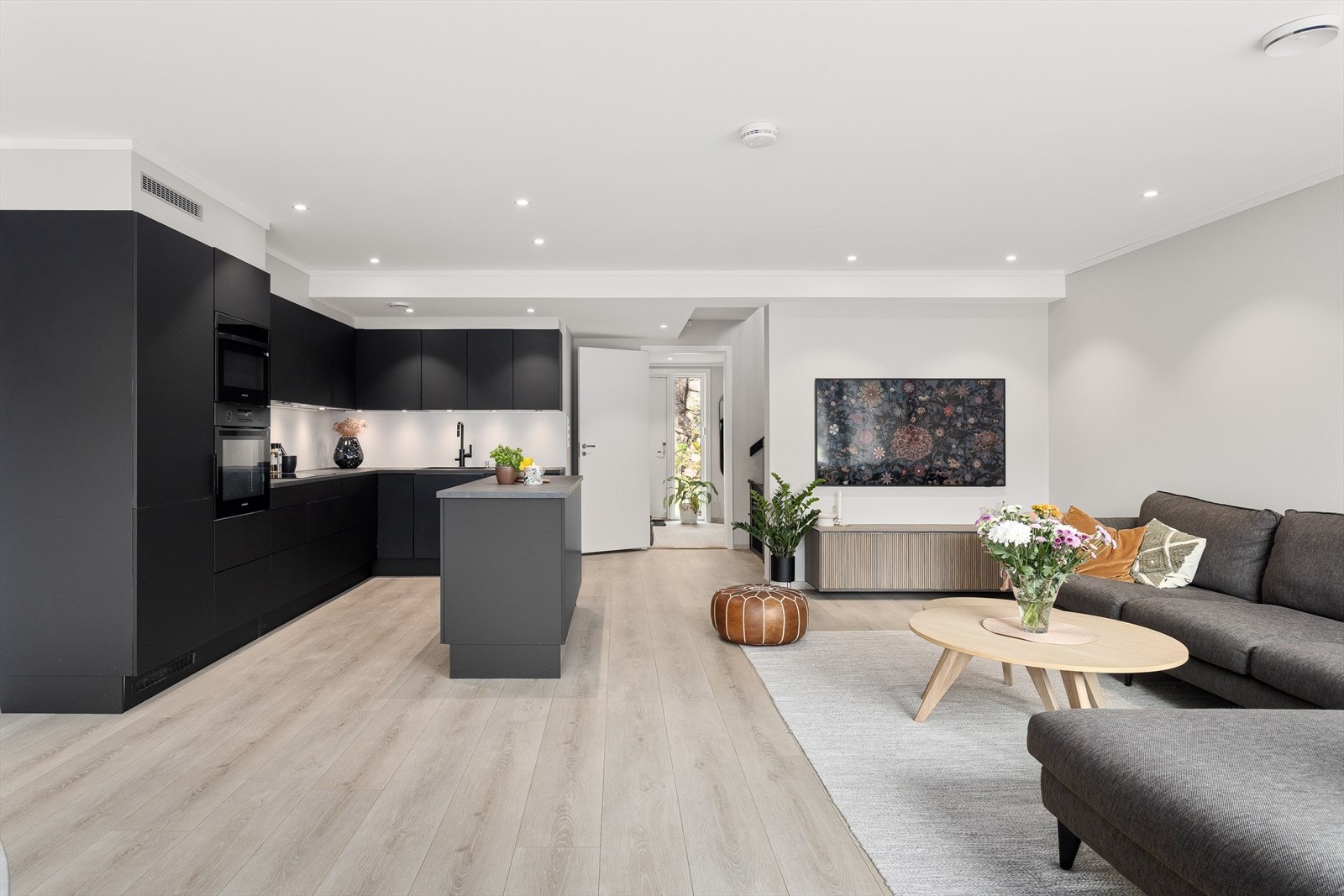 Stuen og kjøkkenet er innredet med moderne farger som skaper en innbydende og harmonisk atmosfære. Galleribilde