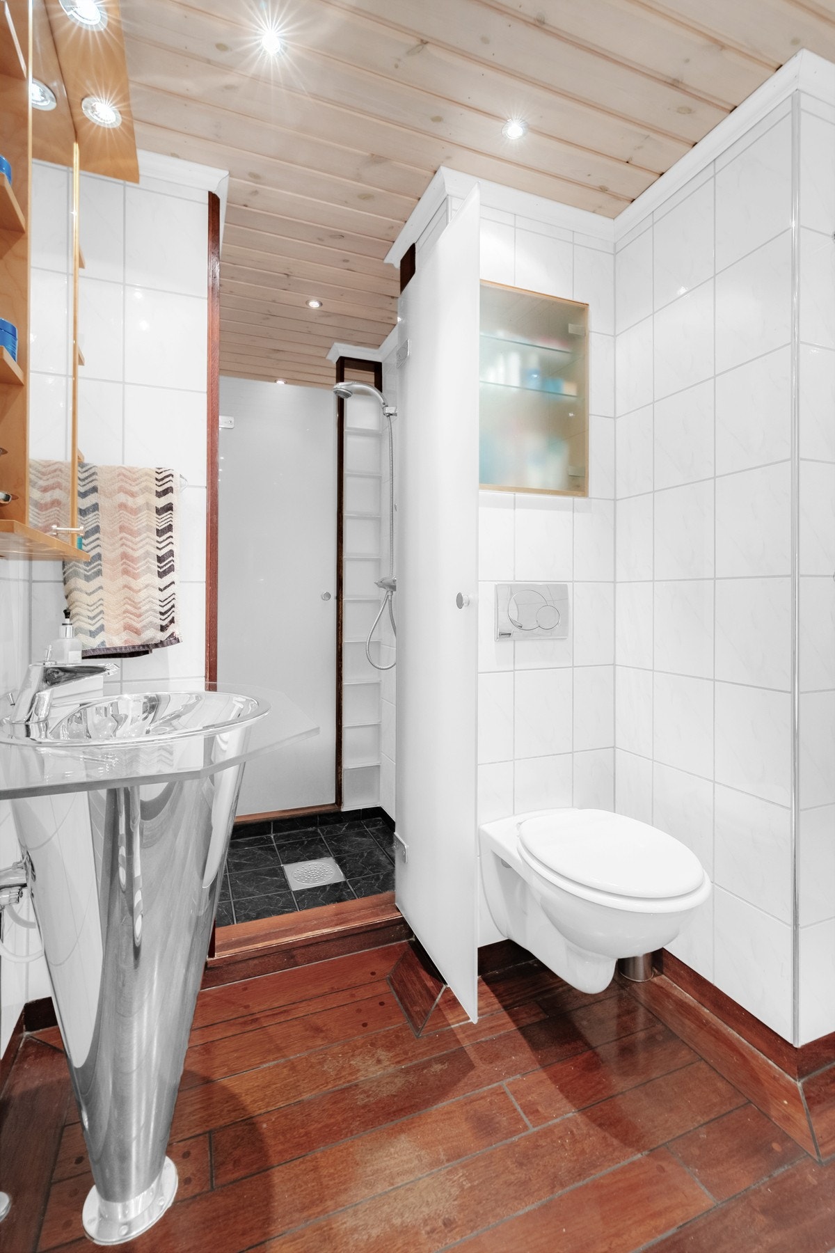 Dusjsone som deler baderommet i to med toalett på hver side av dusjsonen Galleribilde