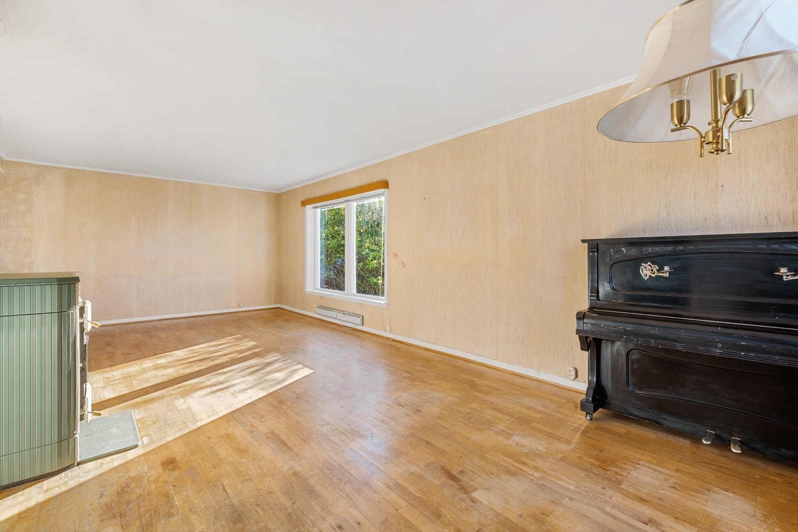 Stuen har ildsted som skaper hygge og ikke minst rask oppvarming på kjølige høst-/vinterkvelder Galleribilde