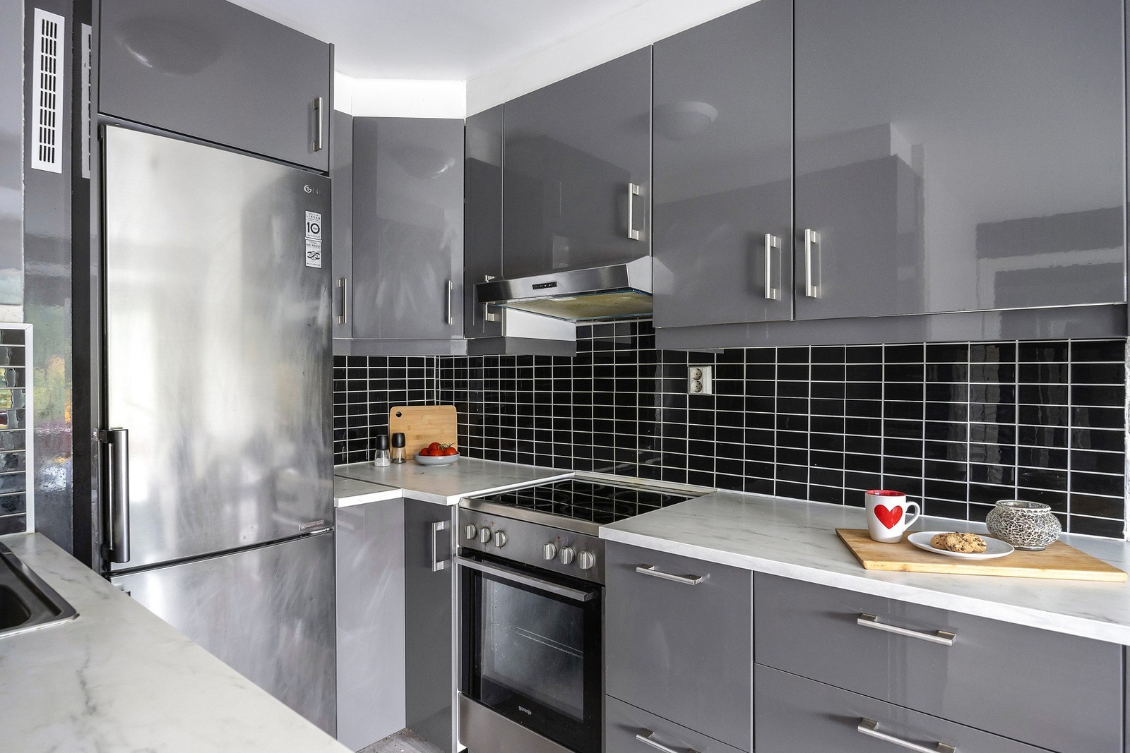 Kjøkken har frittstående hvitevarer som kjøl/fryseskap, oppvaskmaskin og komfyr. Galleribilde