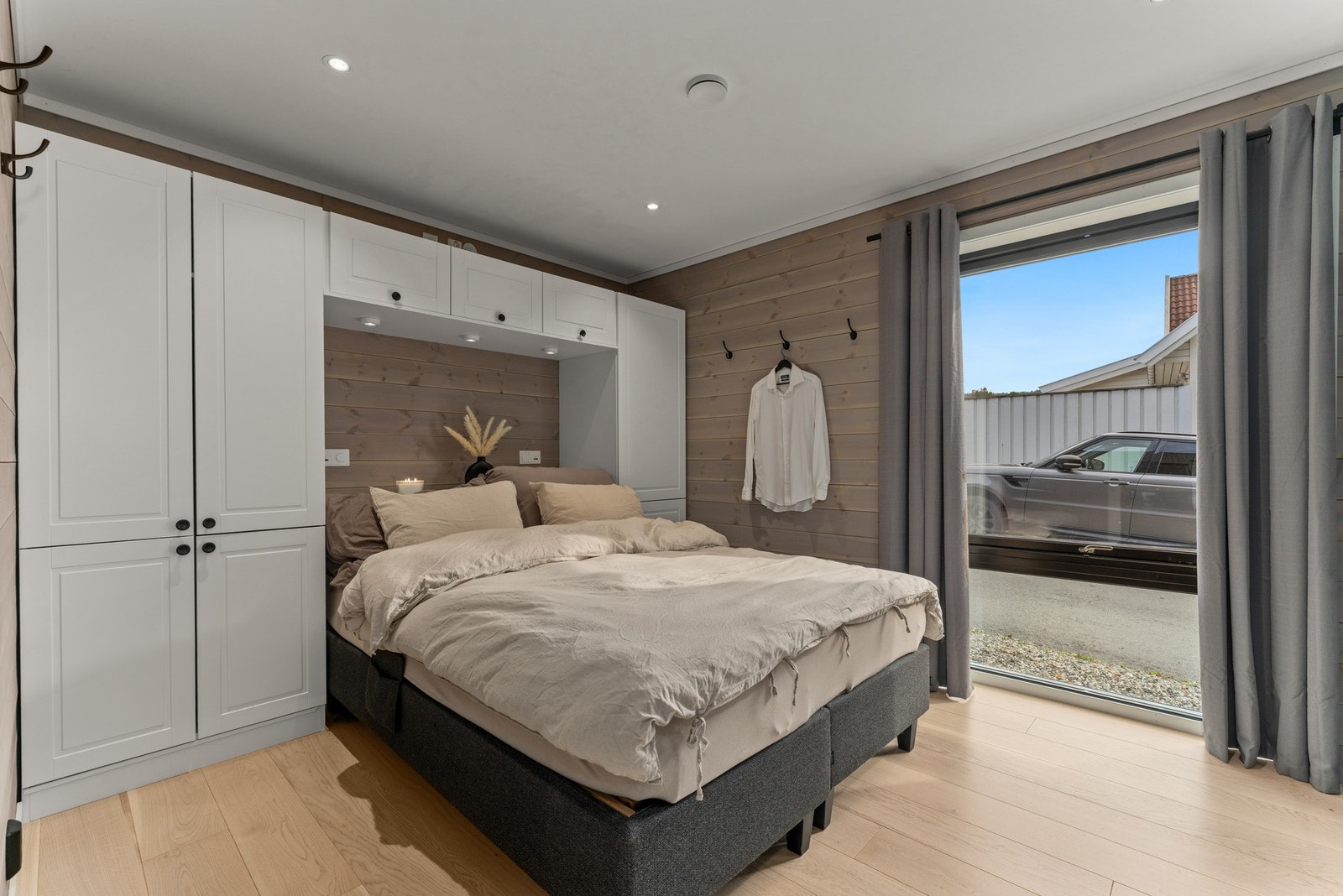 Hovedsoverommet er romslig og elegant, med innebygde garderobeskap rundt sengen, og skyvedørsgarderobe med speil, som gir både funksjon og stil. Galleribilde