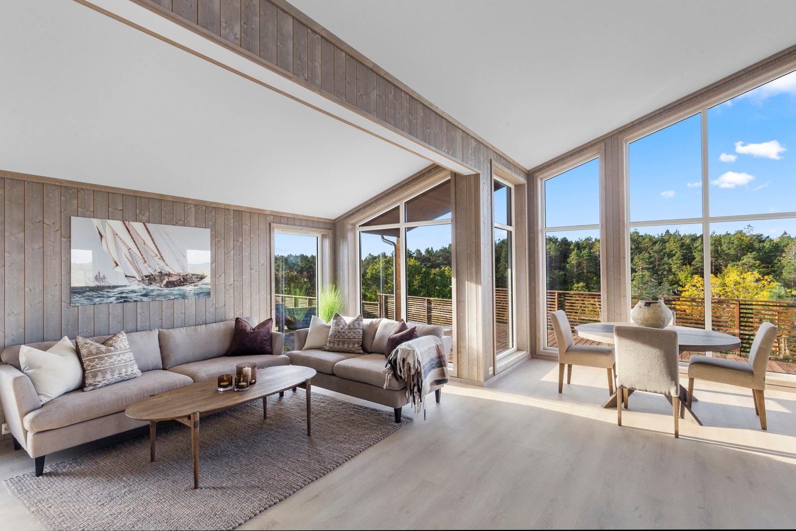 Stuen er luftig med åpen himling og store vindusflater fra gulv til tak. Galleribilde
