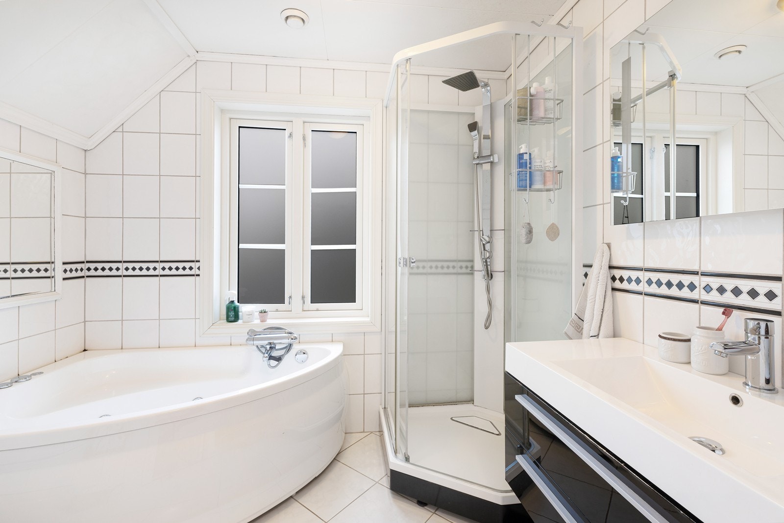 Romslig flislagt bad med badekar, dusjkabinett, wc og servant Galleribilde
