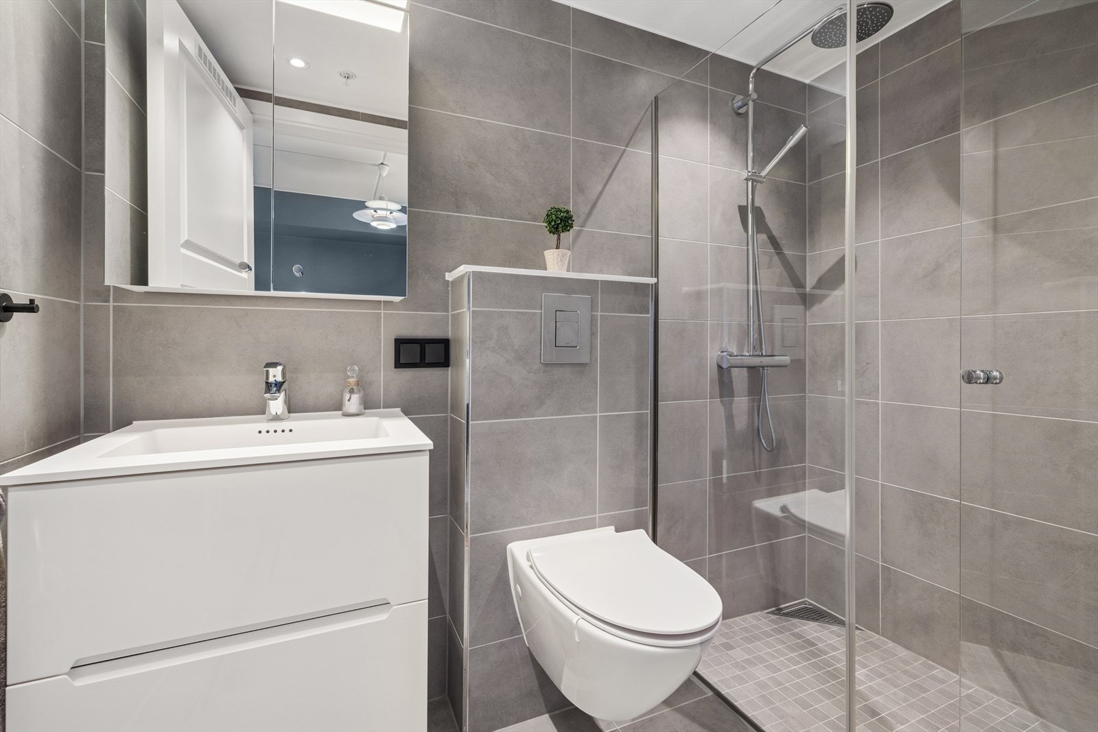 Fra hovedsoverommet er det adkomst til eget bad. Rommet er utstyrt med baderomsinnredning med nedfelt servant, dusjhjørne og veggmontert toalett. Galleribilde