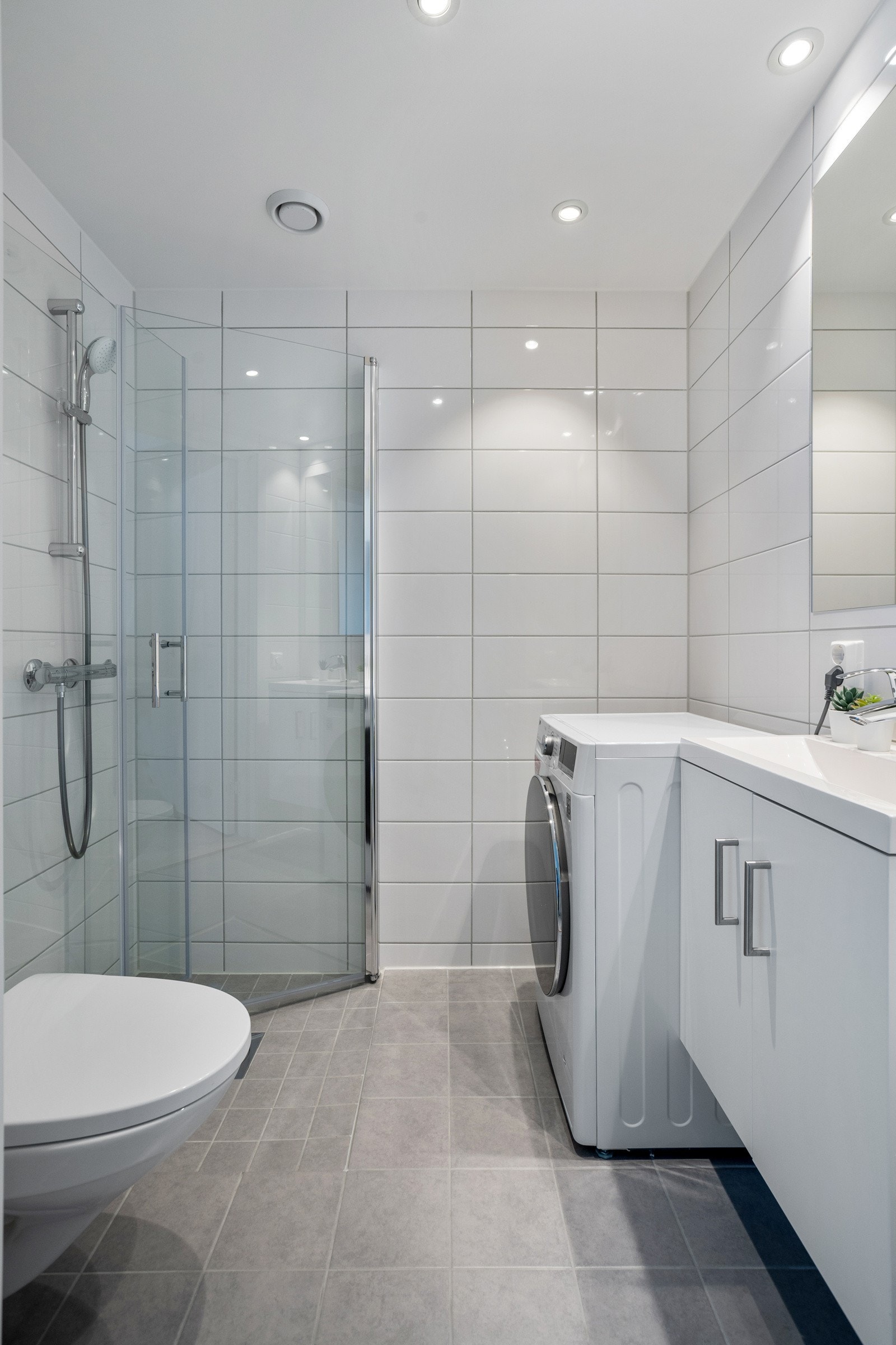 Pent flislagt bad i utleiedel med gulvvarme og opplegg for vaskemaskin. Galleribilde