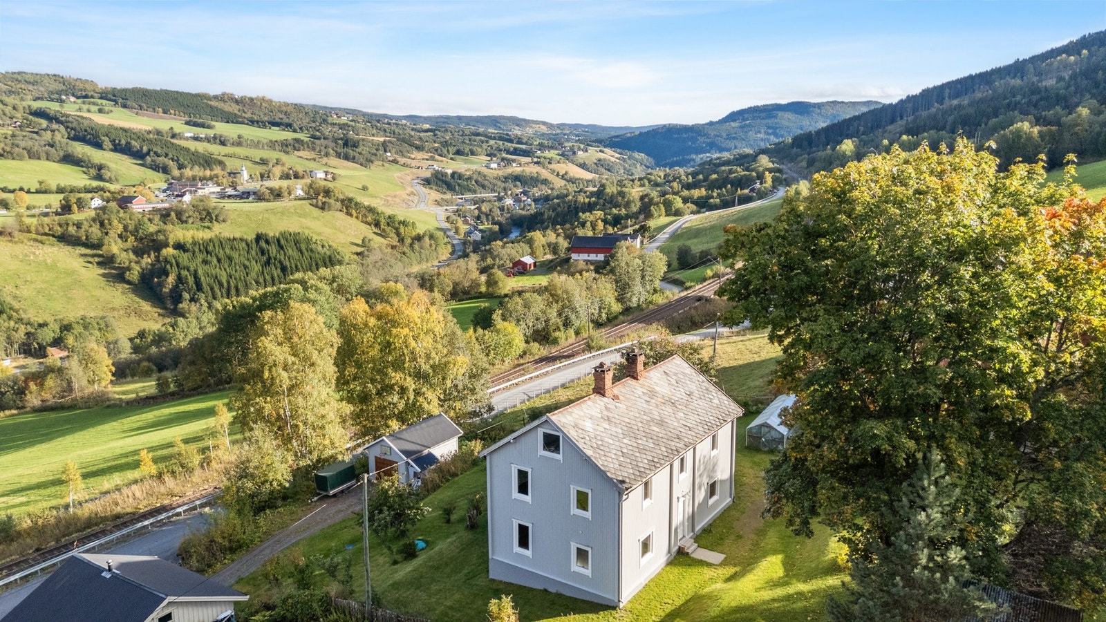 Eiendommen består av garasje, bolig og drivhus. Galleribilde