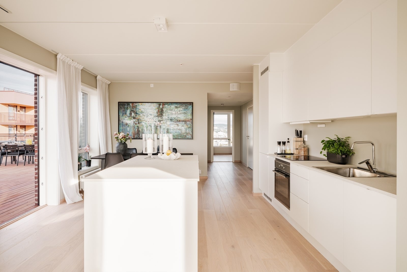 Kjøkkenet er fra Sigdal med glatte, folierte fronter og laminat benkeplate med nedfelt kum i rustfritt stål. Galleribilde