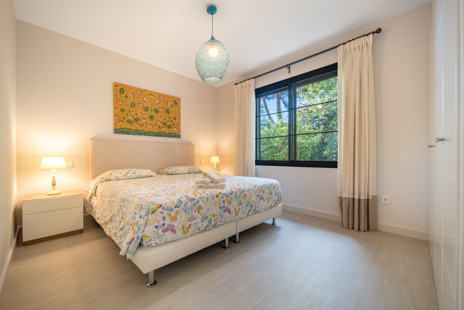 Step into a light-filled guest bedroom with south-facing views and plenty of storage. Perfect for families and groups, this serene space ensures relaxing nights and a welcoming atmosphere at Casa Salma. Galleribilde