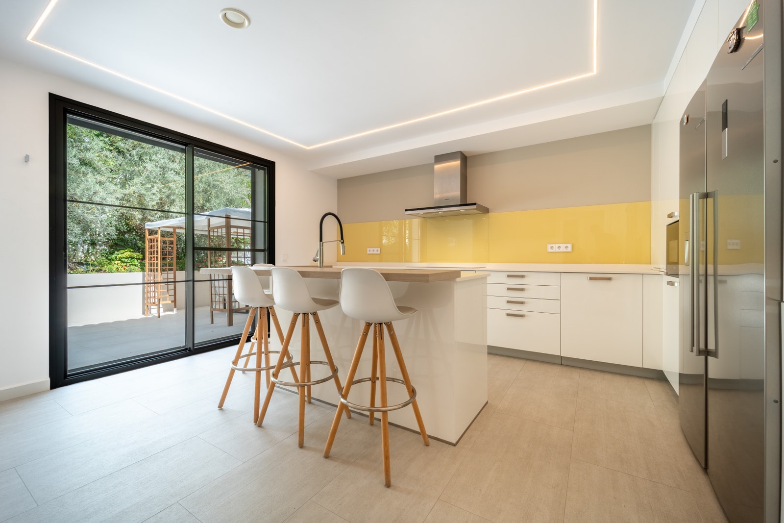 Lyst, moderne kjøkken på Casa Salma med skyvedører som åpner ut mot terrassen og utendørs grill- og spiseplass. Dette gjennomtenkte rommet er ideelt for å tilberede familiemåltider og underholde gjester, og kombinerer innendørs komfort med enkel tilgang t Galleribilde