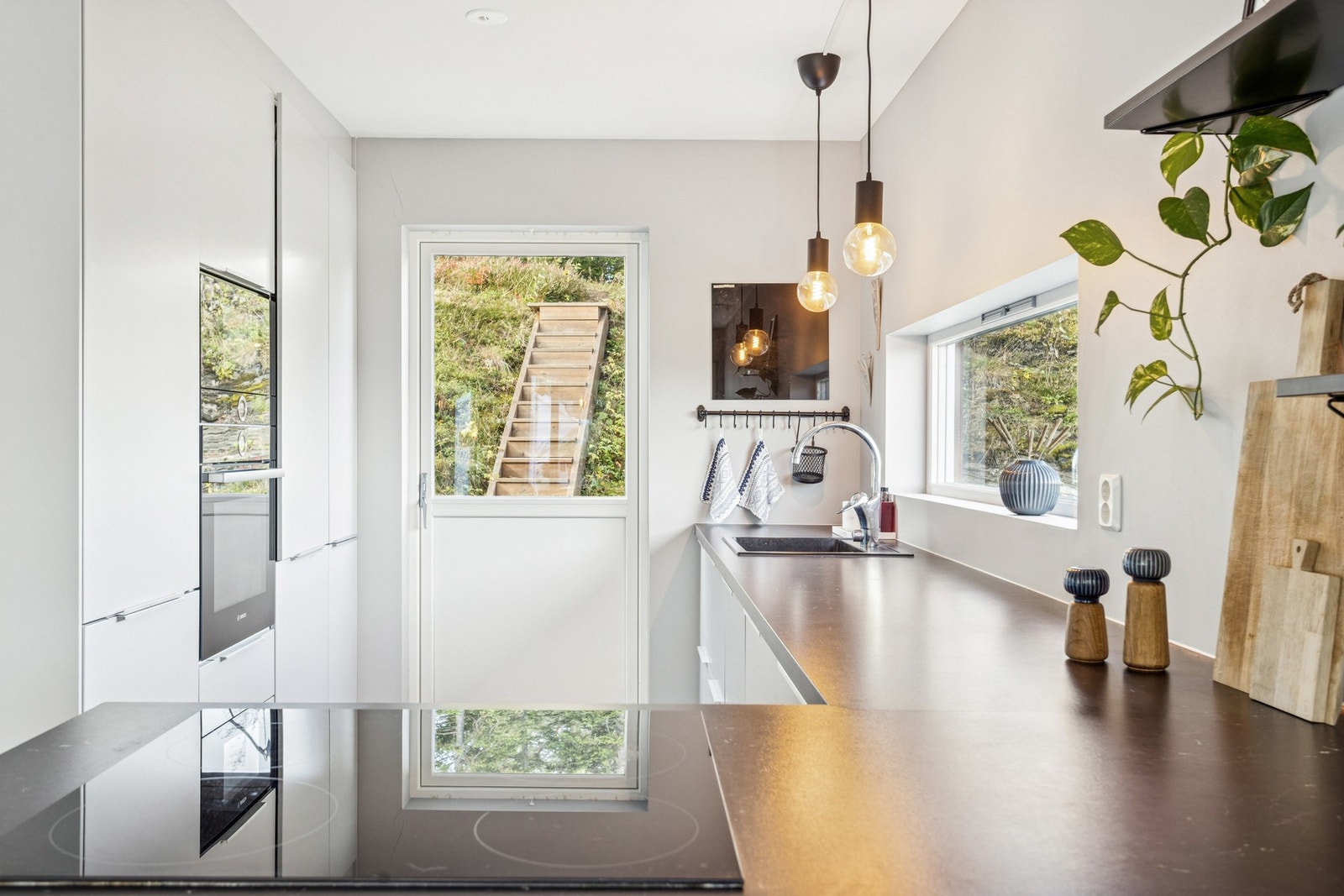 Moderne og stilrent kjøkken med godt av arbeidsplass og integrerte løsninger. Galleribilde