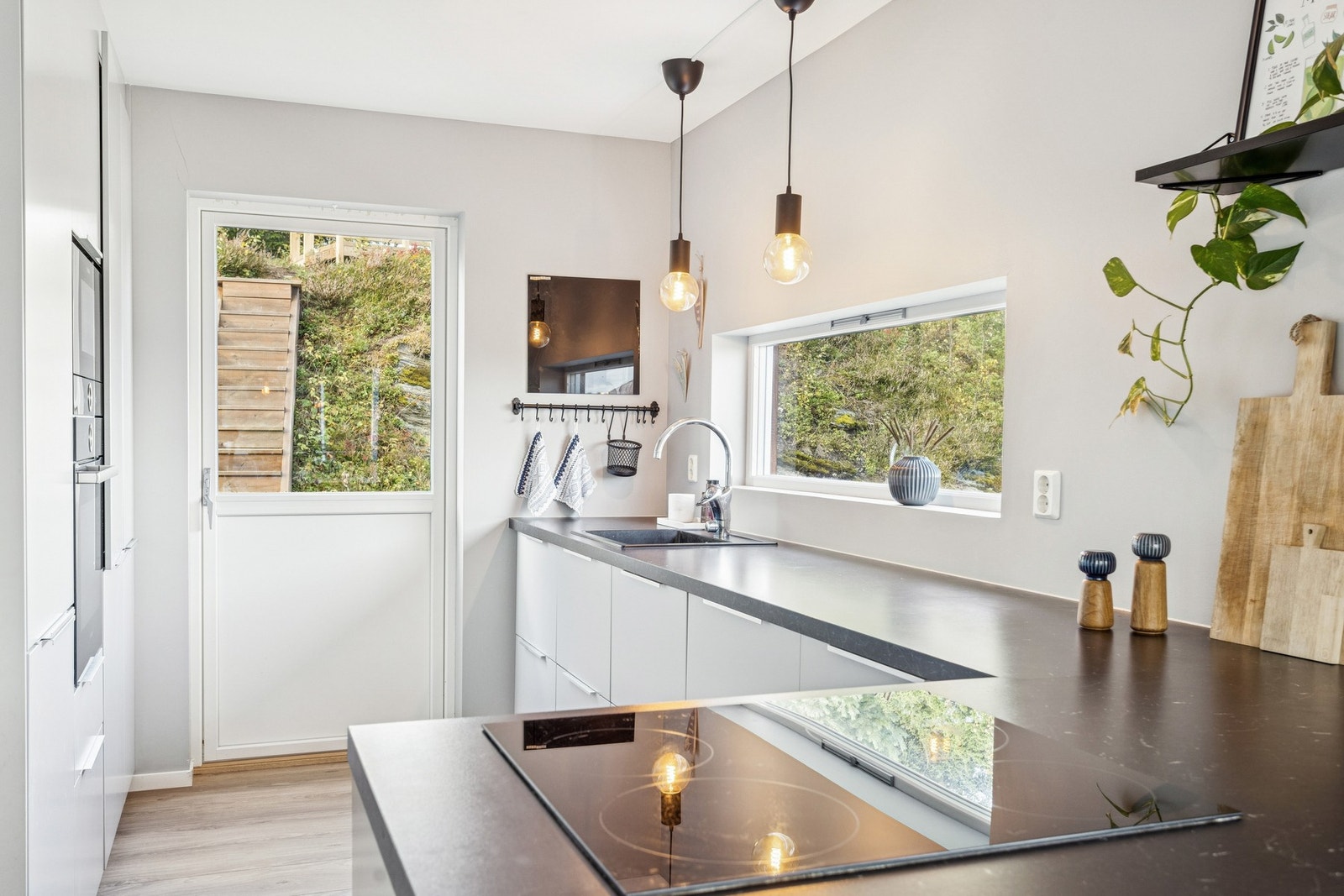 Kjøkkenet er holdt i et stilrent uttrykk med helhetlig finish og utgang til uteplassen. Galleribilde