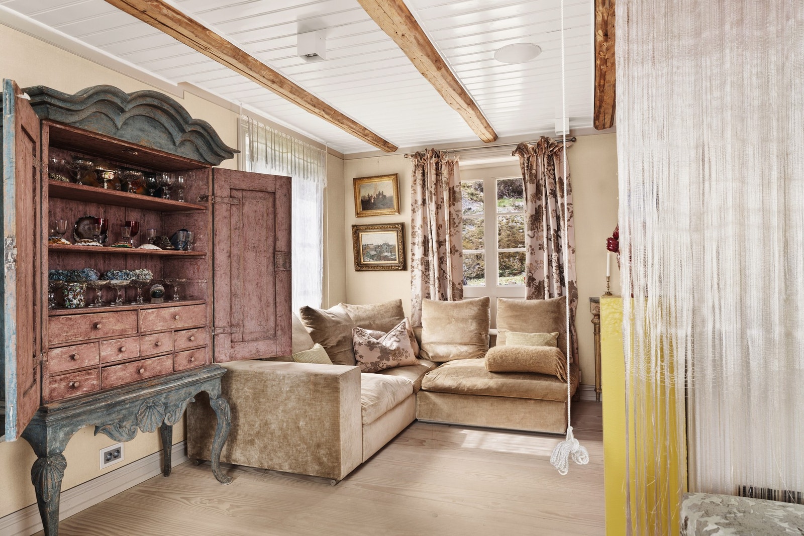 Lun og innbydende stuekrok med delikate tekstiler, originale detaljer og store vinduer som slipper inn rikelig med naturlig lys. Galleribilde