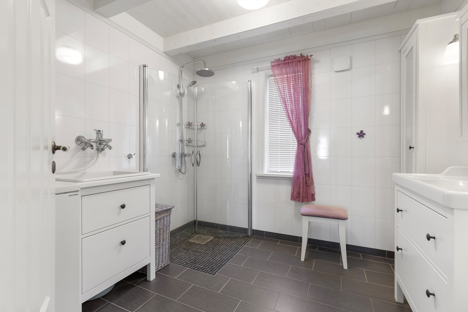 Bad i hovedetasjen har flislagt gulv med varmekabel og våtromsplater på vegg | rommet er utstyrt med baderomsinnredning, wc, dusjvegger, skyllekar og røropplegg for vaskemaskin Galleribilde