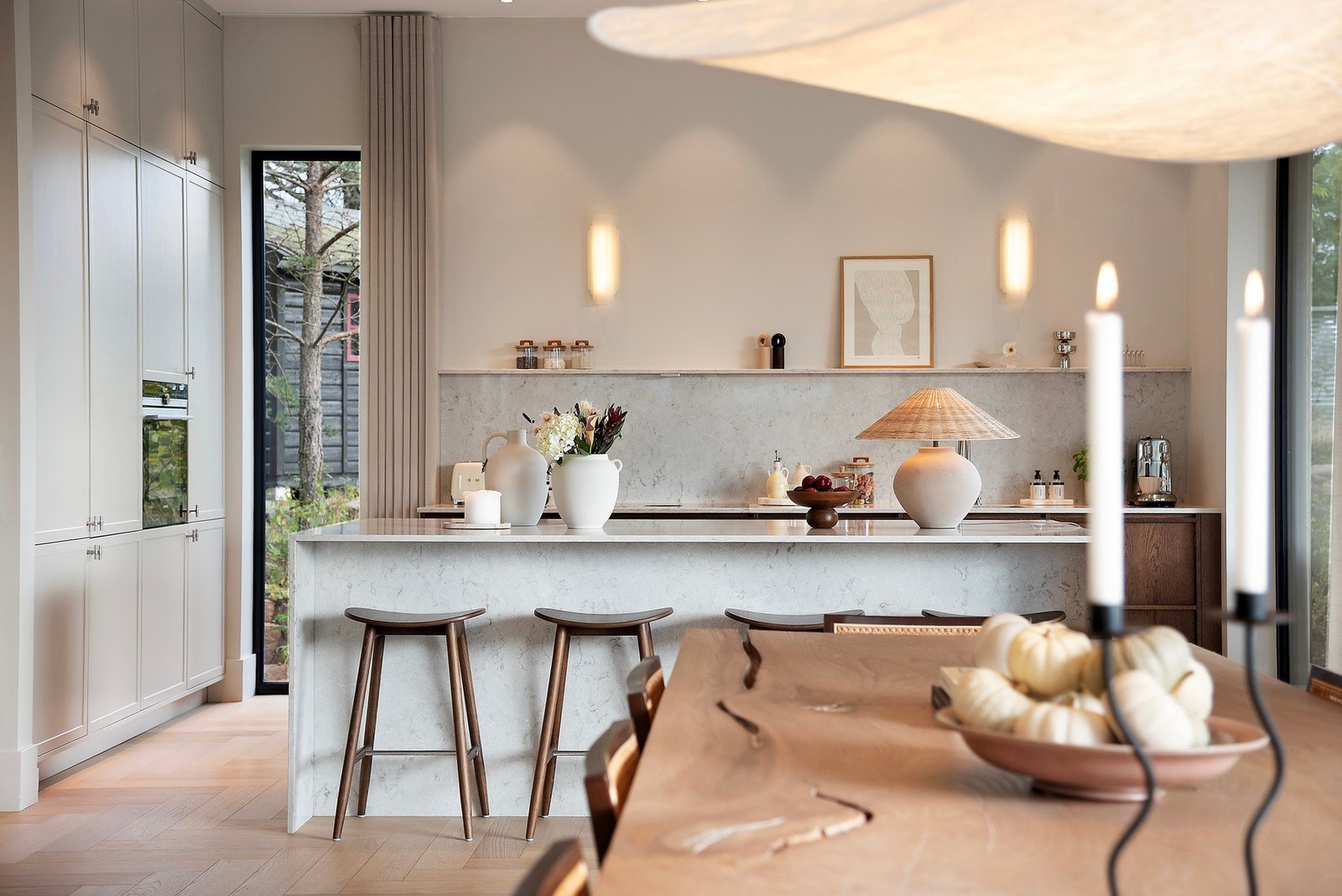 Den gode takhøyden fremheves av de lange gardinene og kjøkkeninnredningen som strekker seg elegant opp mot taket Galleribilde