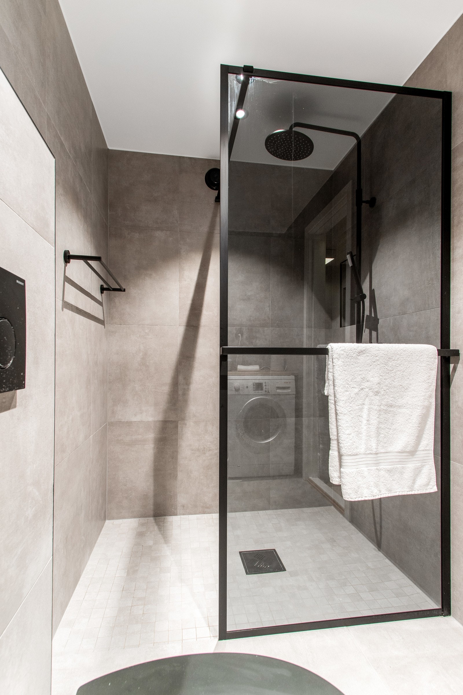 Alle armaturer, lister på dusjveggen, trykkplaten, toalettsete og håndklestangen er holdt i et trendy, sort design. Galleribilde