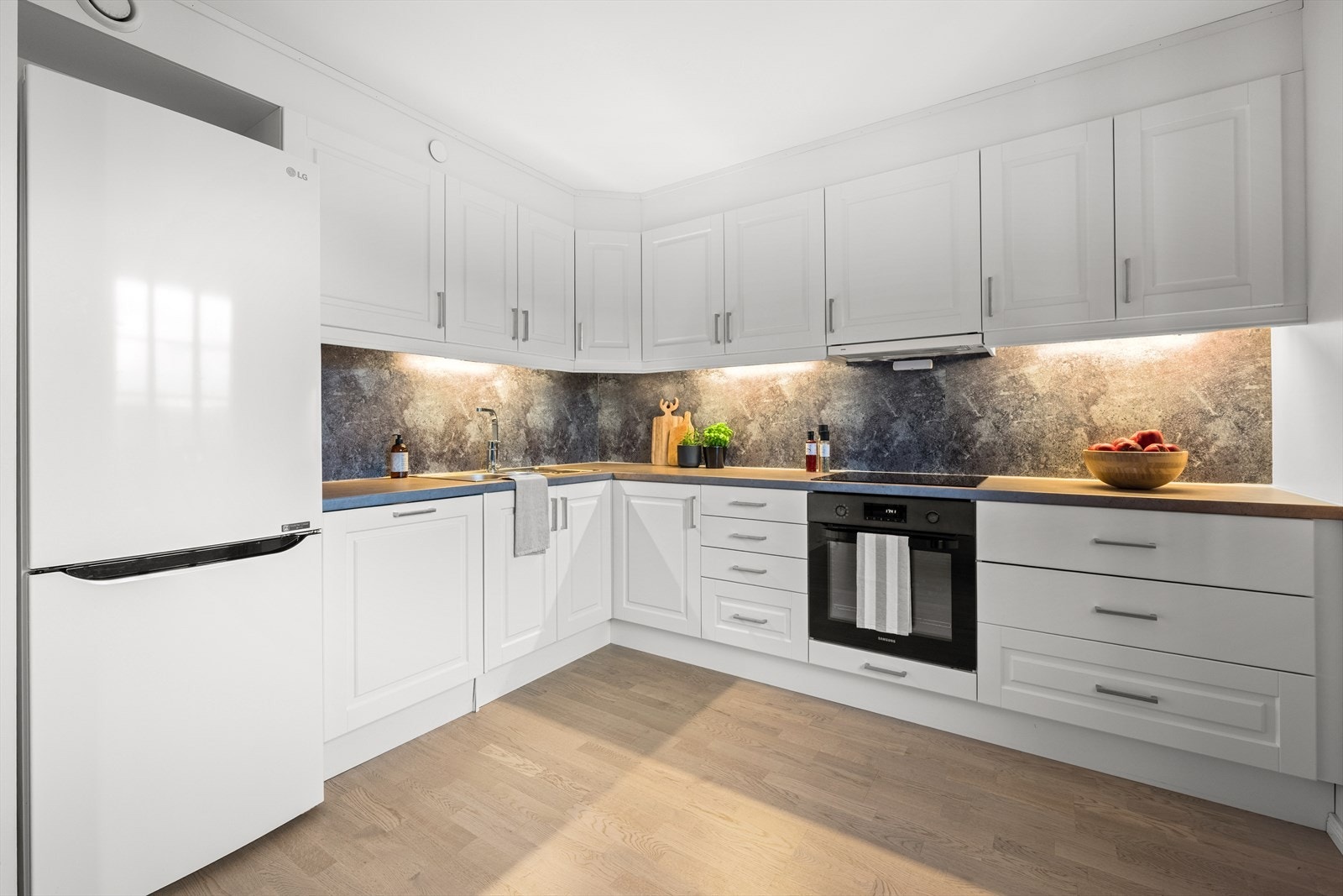 Det er frittstående kjøle-/fryseskap, integrert oppvaskmaskin, induksjonstopp og stekeovn. Galleribilde