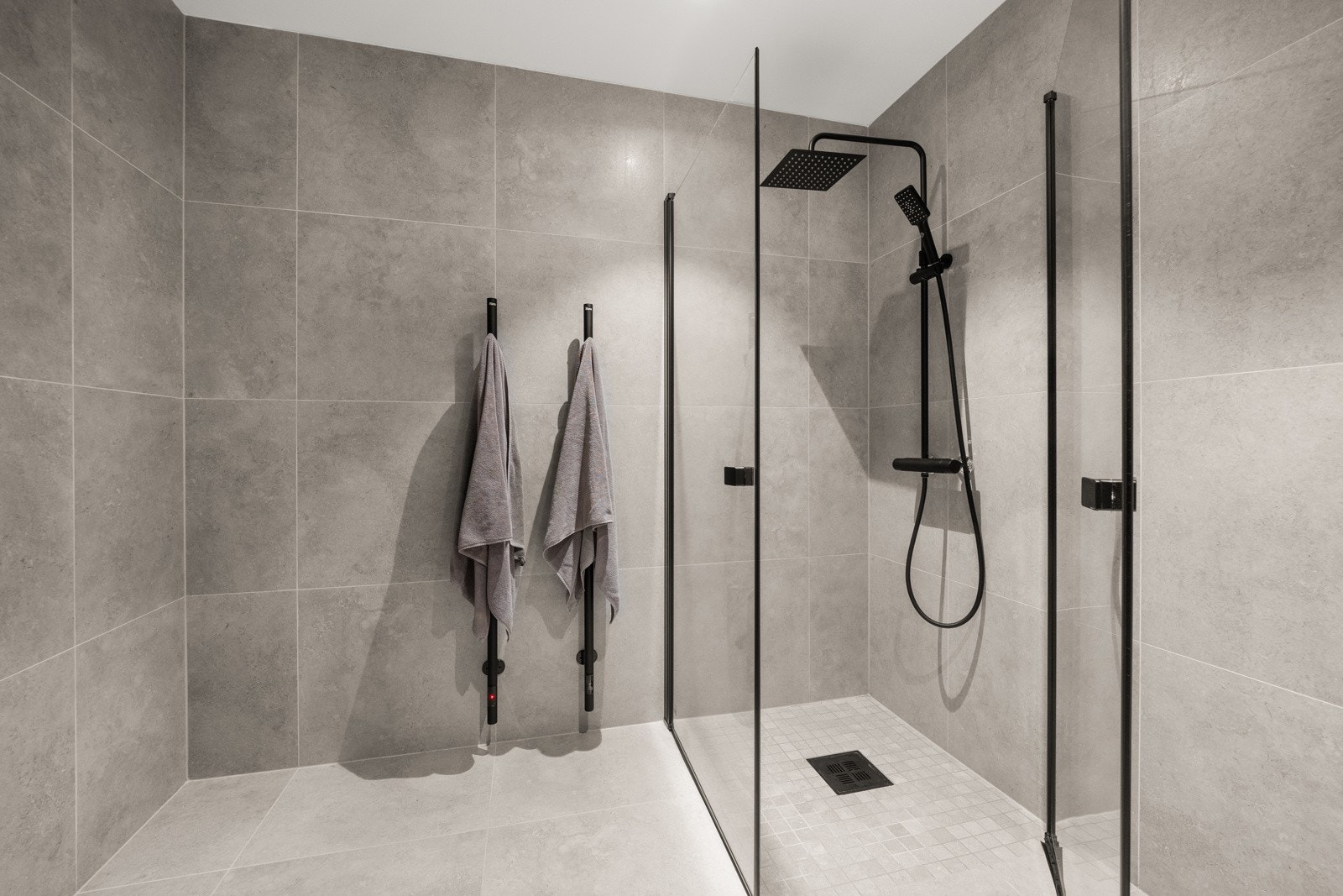 Regnfallsdusj i hjørnet. Gjennomgående sorte detaljer i hele leiligheten. Galleribilde