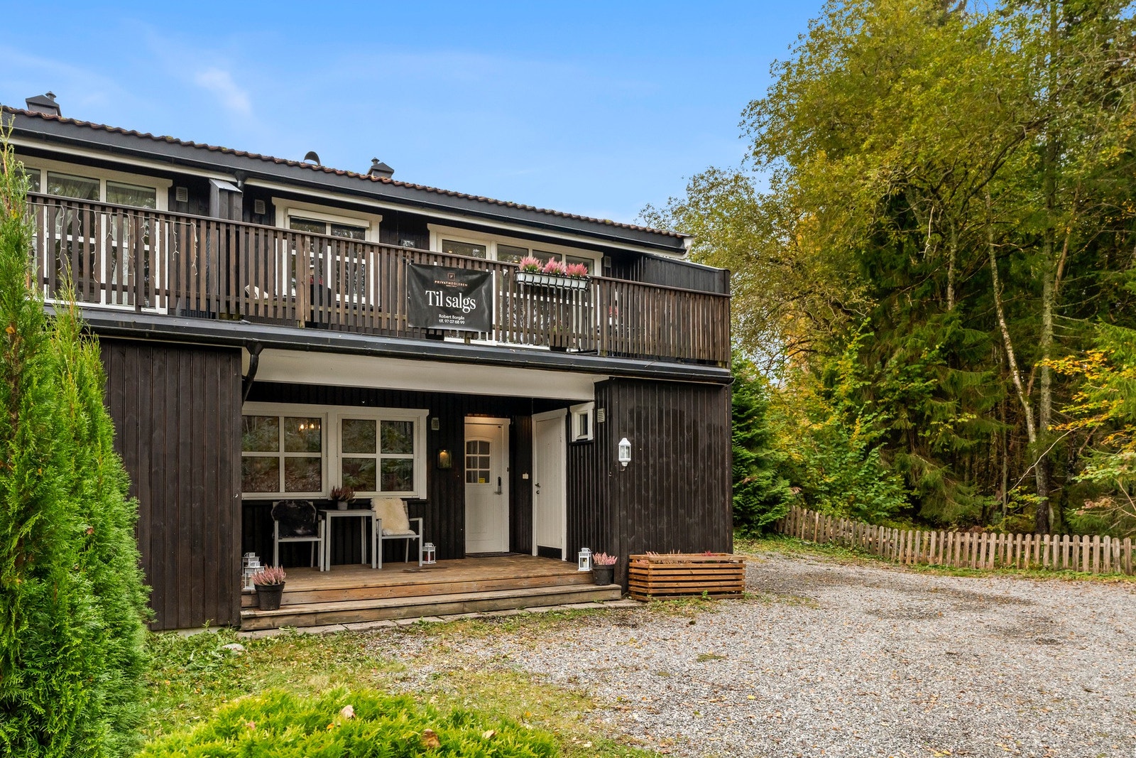 Biloppstillingsplass med el-lader på husets endevegg. Galleribilde