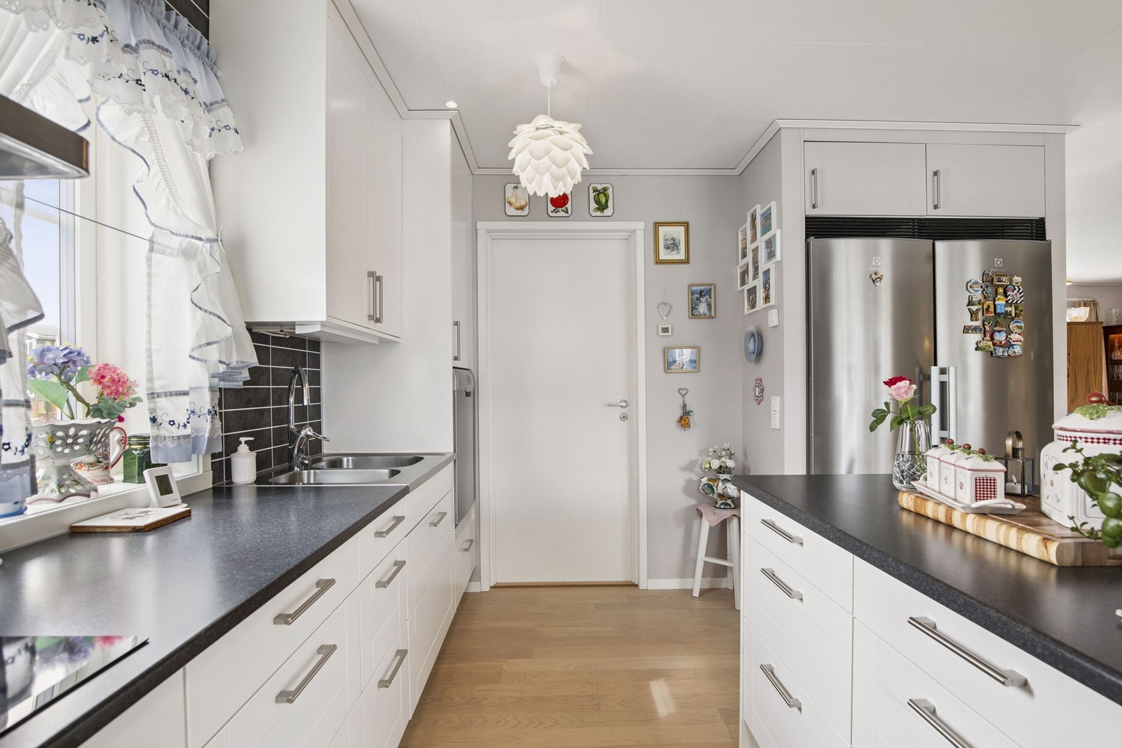 Kjøkkenet har rikelig med skapplass og praktisk hjørneskap med karusell for smart oppbevaring. Egen nisje til frittstående kjøleskap og fryseskap Galleribilde