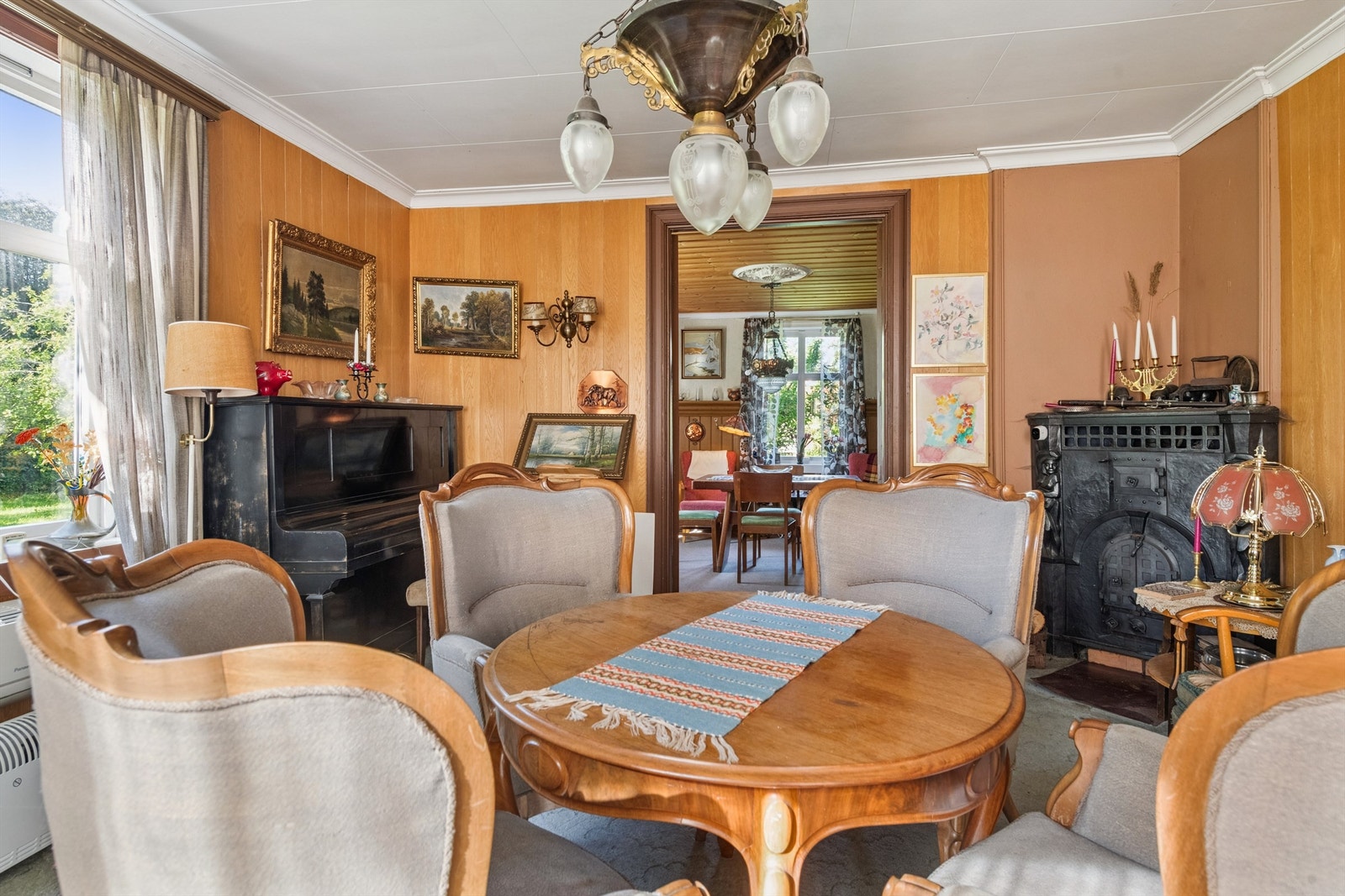 Stuen har varmepumpe montert på veggen under vindu. Galleribilde