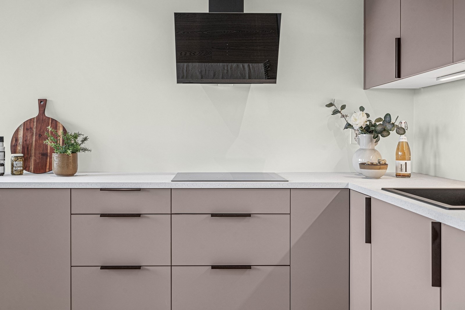 Benkeplaten er av laminat. kjøkkenventilator over kokesone. Galleribilde